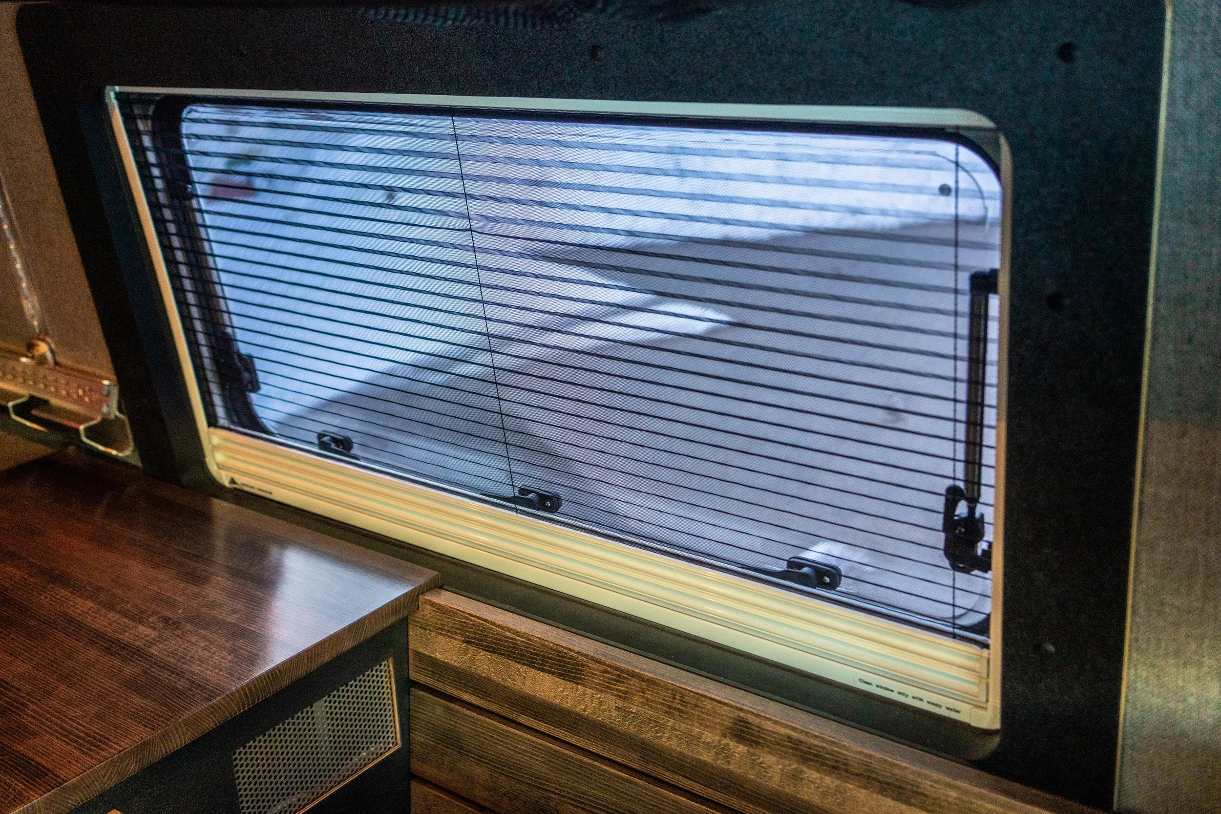 Close-up of a vintage fridge with a glass door showing a view inside the freezer.