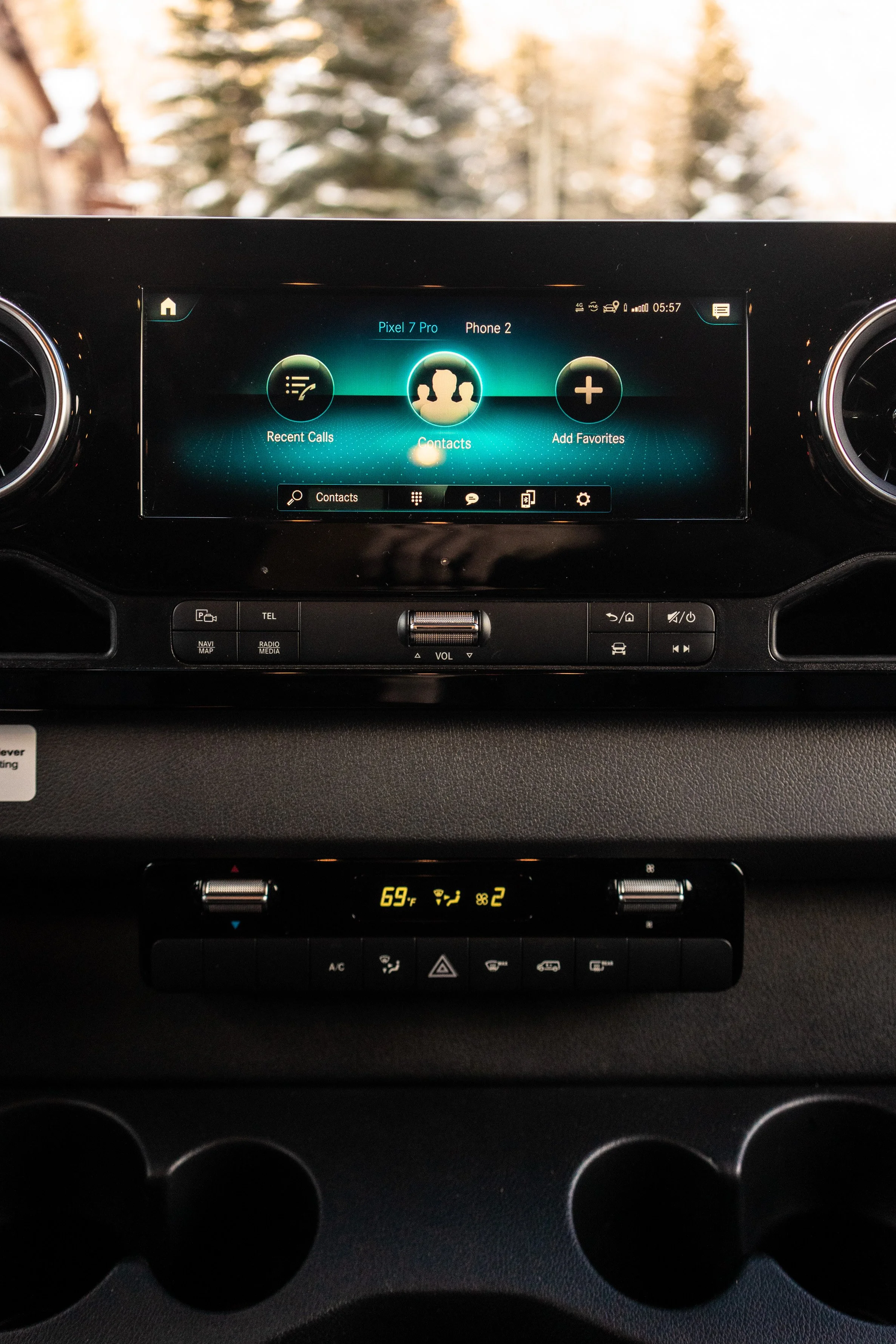 Car dashboard with a touchscreen displaying contact options, and climate control showing 69°F.