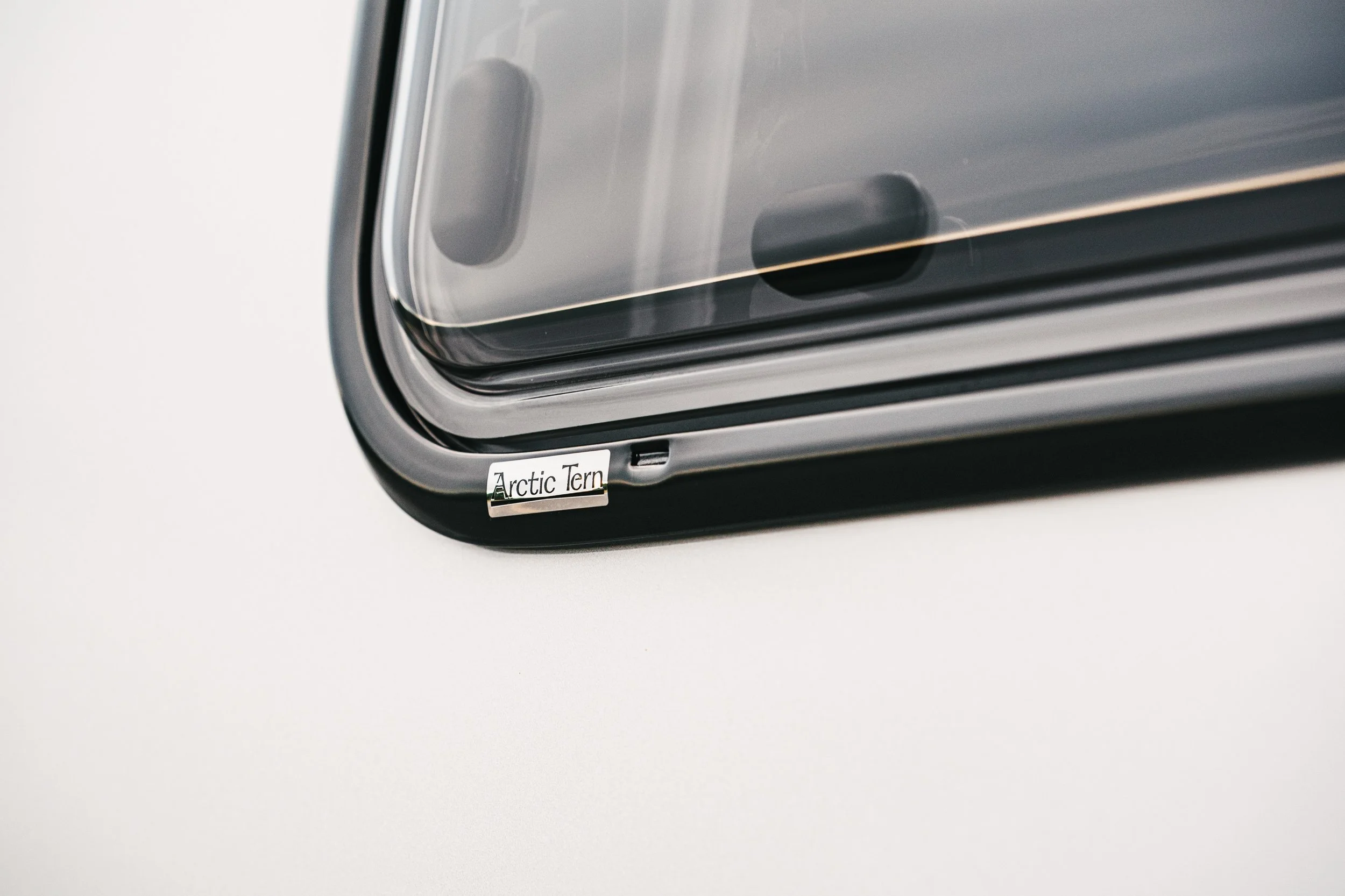 Close-up of a silver electronic device with a small label that reads "Arctic Tern".