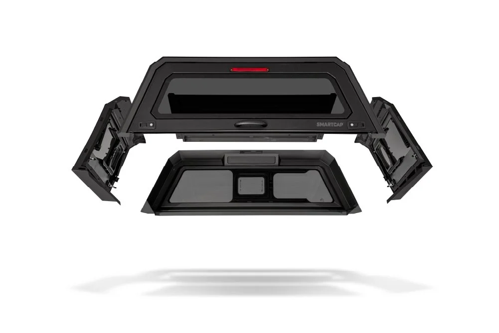 A black truck bed cap with opened side panels and a tinted rear window, shown floating above a white background.