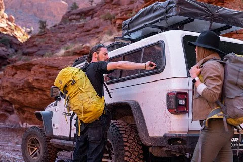 Man getting hiking gear from his ARE Topper
