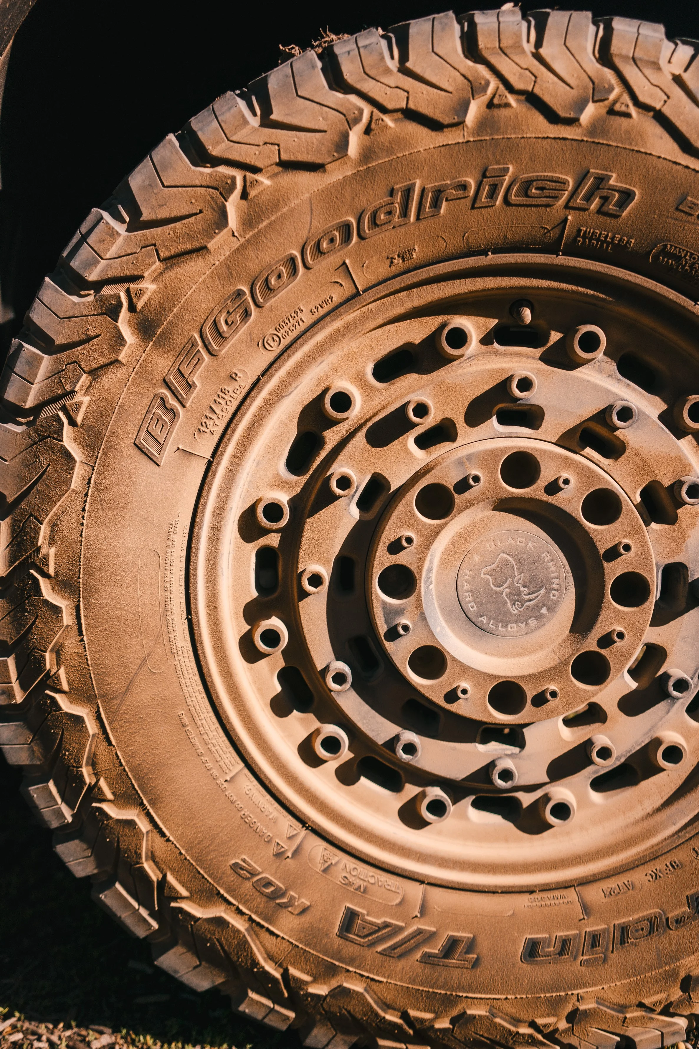 Close-up of a rugged off-road tire with branding markings.