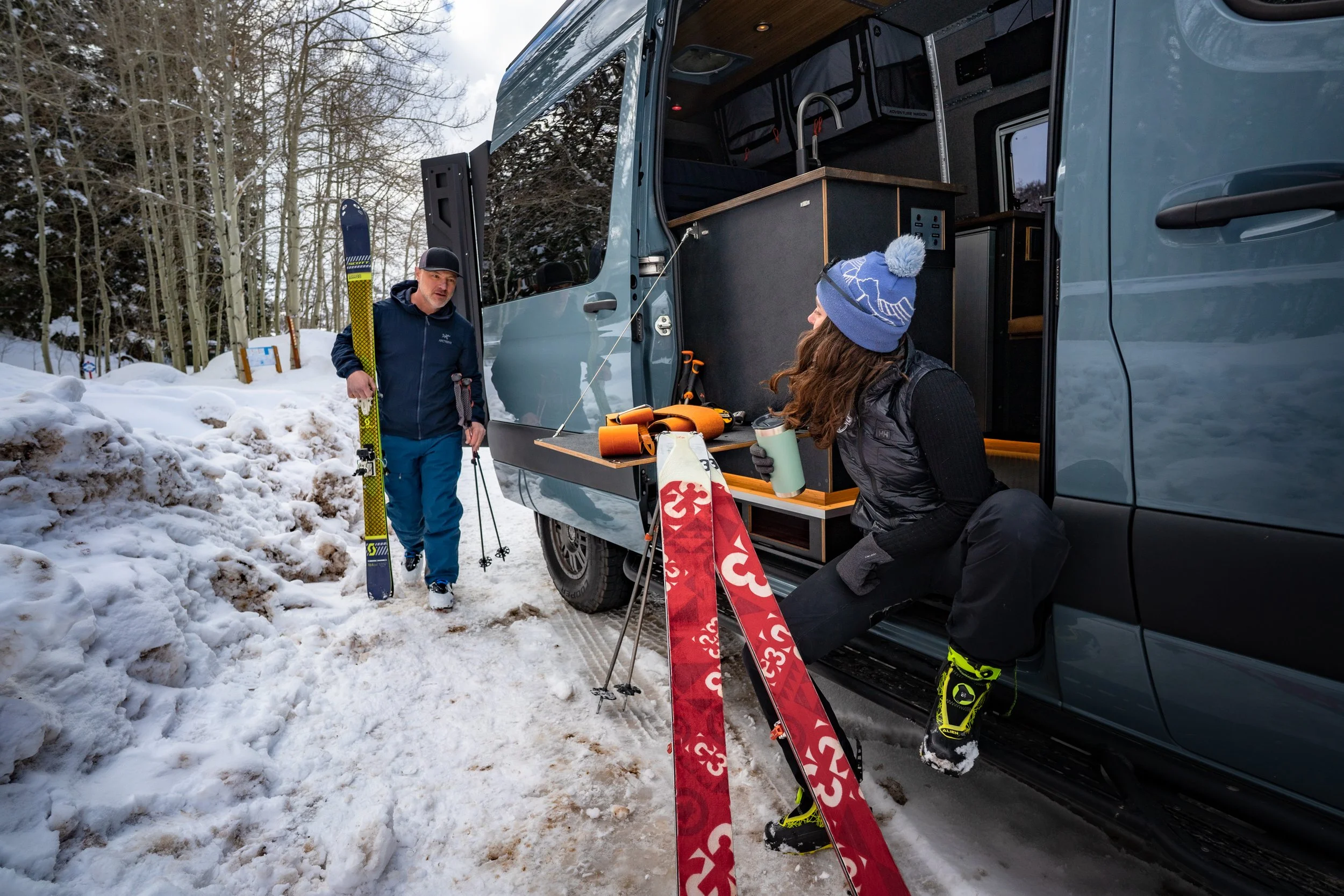 Skiers getting ready in a sprinter van
