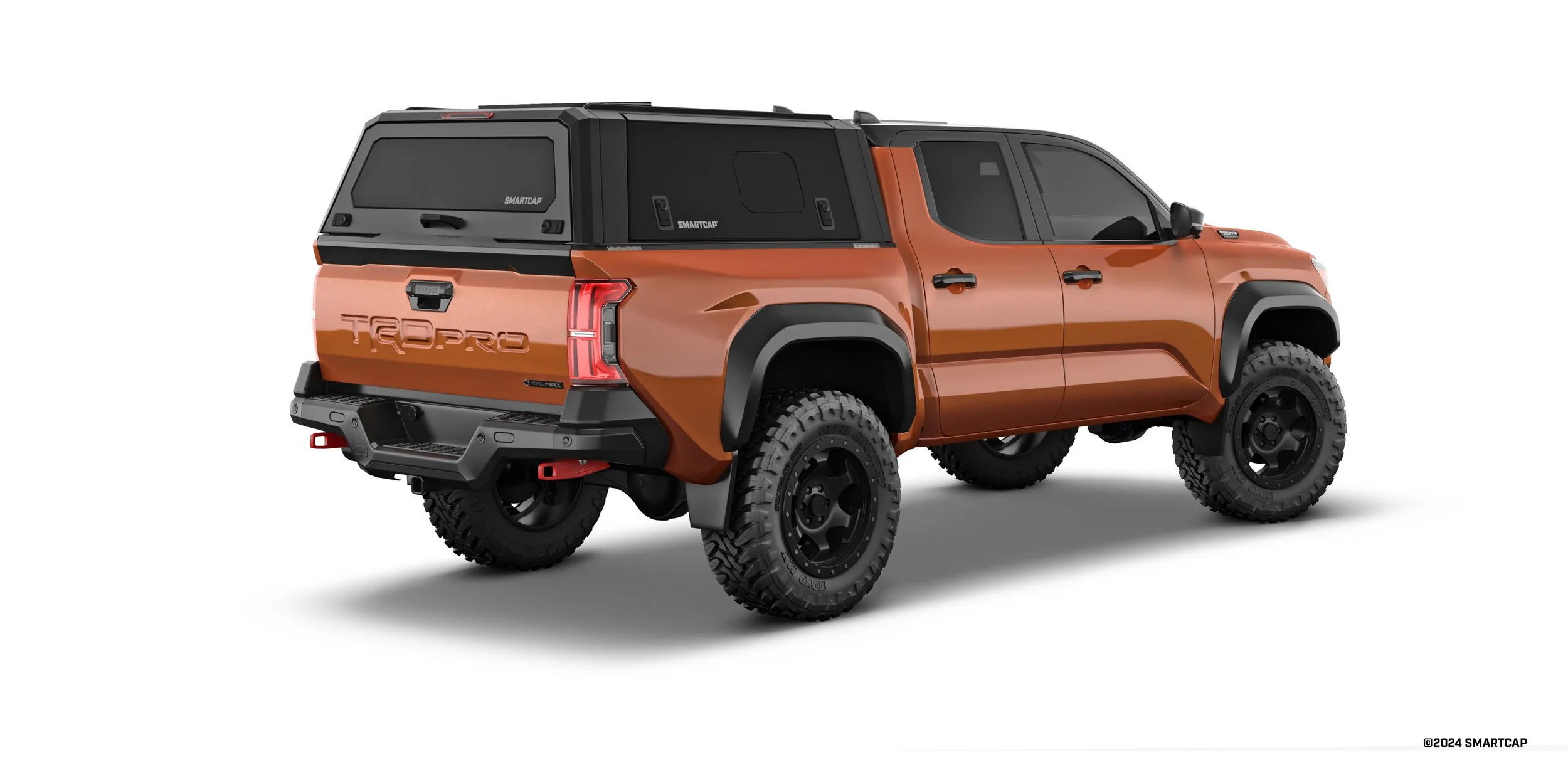 An orange Toyota Tundra TRD Pro pickup truck with a black bed cover and off-road tires, isolated against a white background.