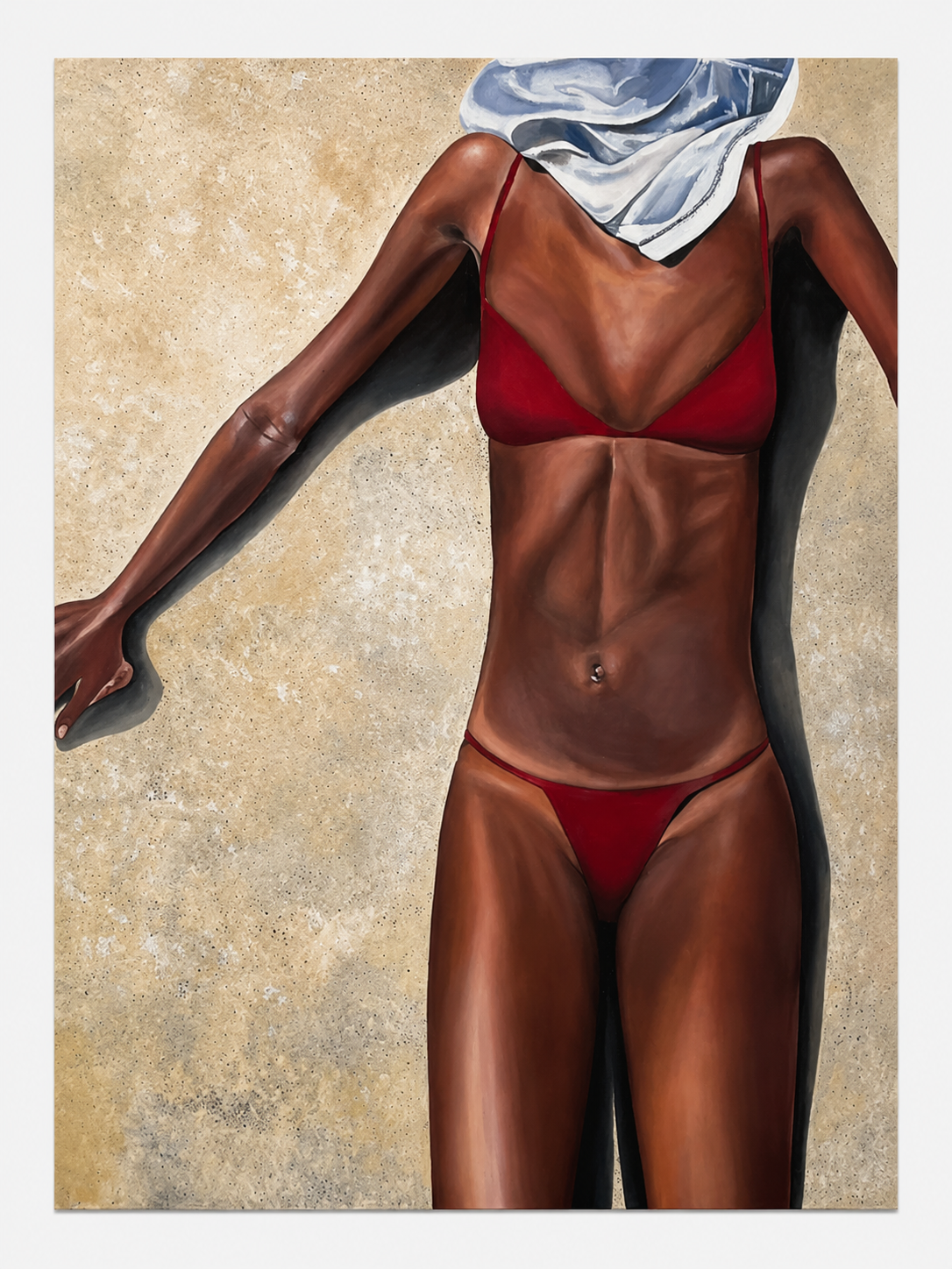 Close-up of a woman in a red bikini lying on a sandy surface with a white towel covering her face.