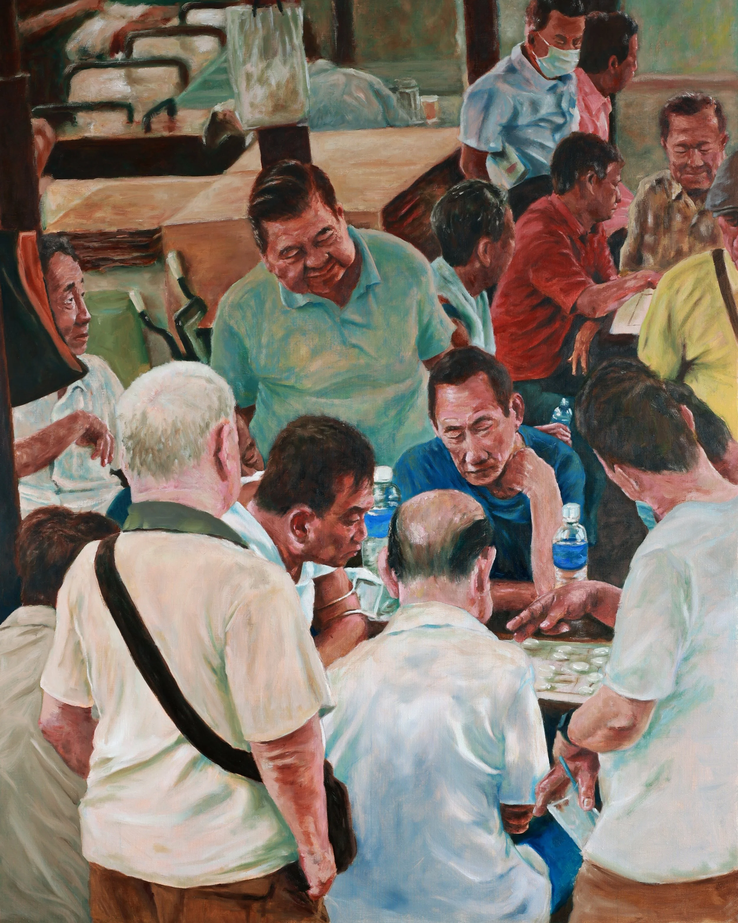 A group of people playing a game of chess in a lively indoor setting, surrounded by onlookers. Some individuals are engaged in conversation, while others observe the game. The scene is vibrant and social, with a mix of men of different ages. One person is wearing a face mask.