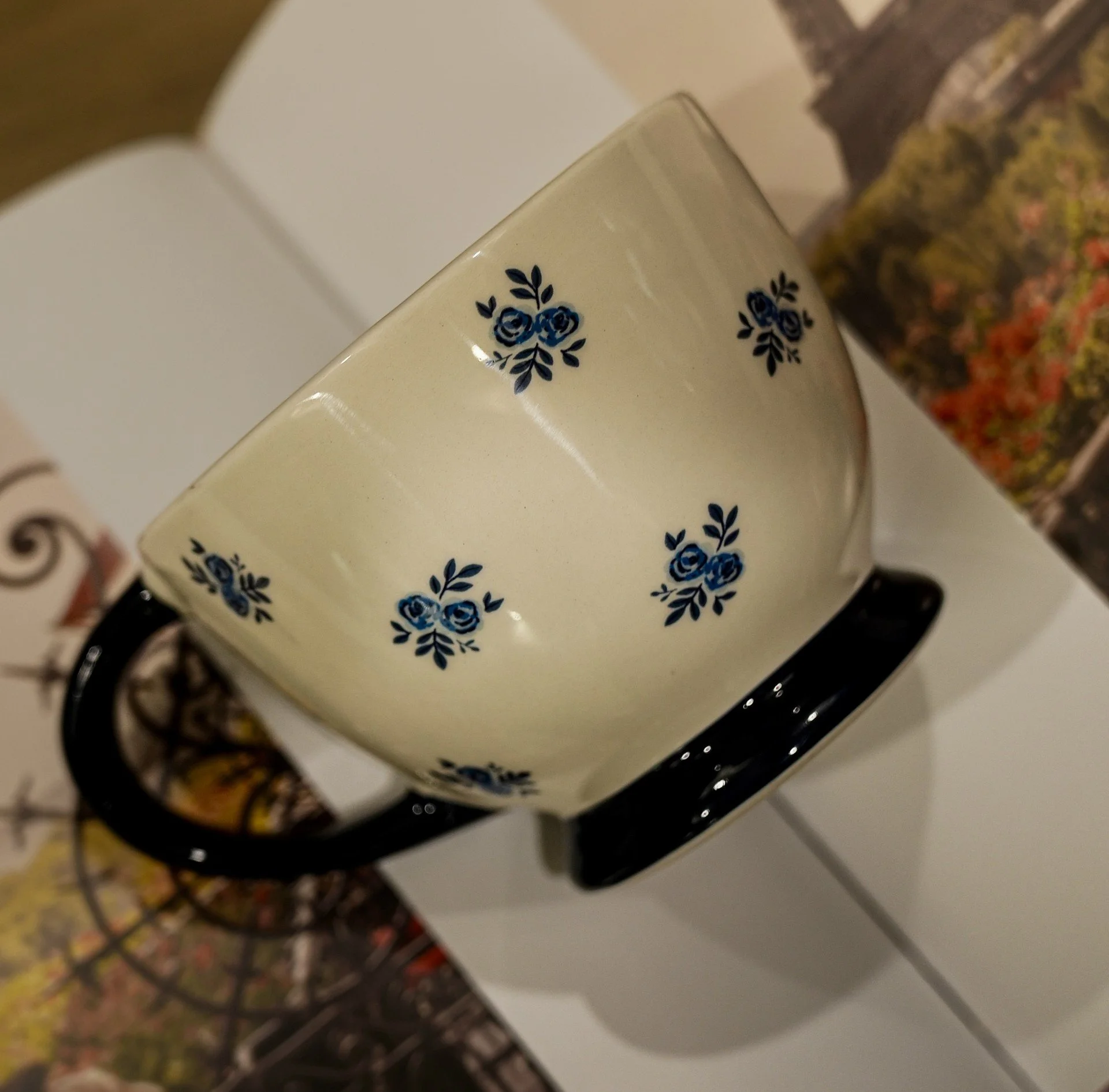 Cream floral teacup-style mug with navy blue handle and base from Kandles2u-Kandles2Mug Collection-perfect for Austin, Texas Candle Making Workshops/Classes. Date Nights, Girls' Nights, Corporate Events, and Bridal Parties.