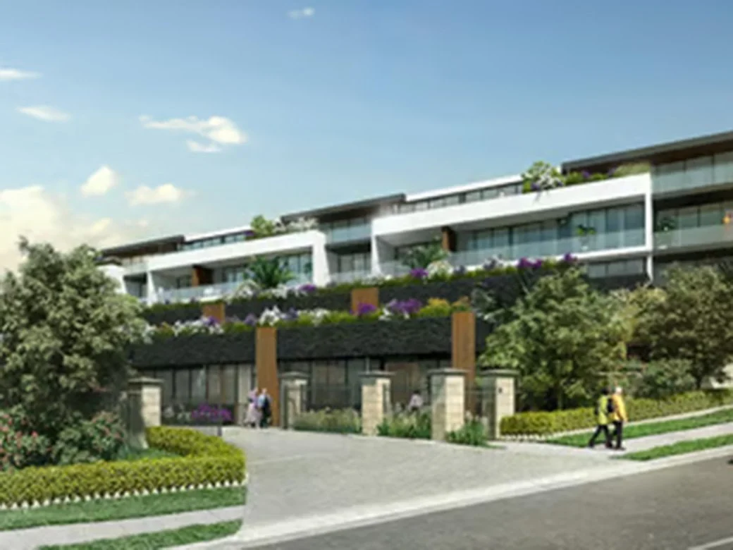 Modern residential building with landscaped gardens and trees