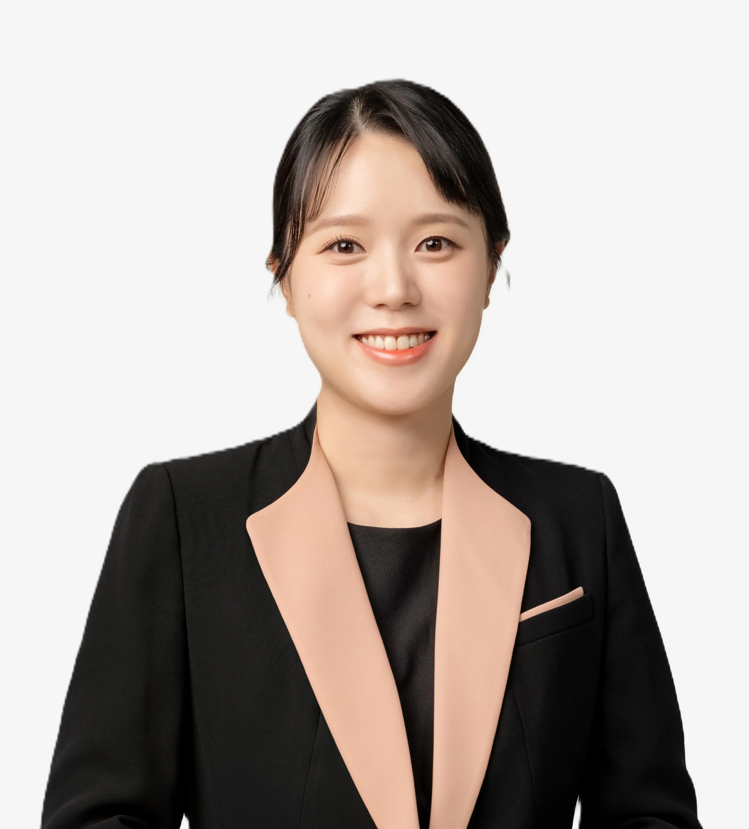 Professional woman with short dark hair, smiling, wearing a black blazer with tan lapel and a black top against a plain white background.