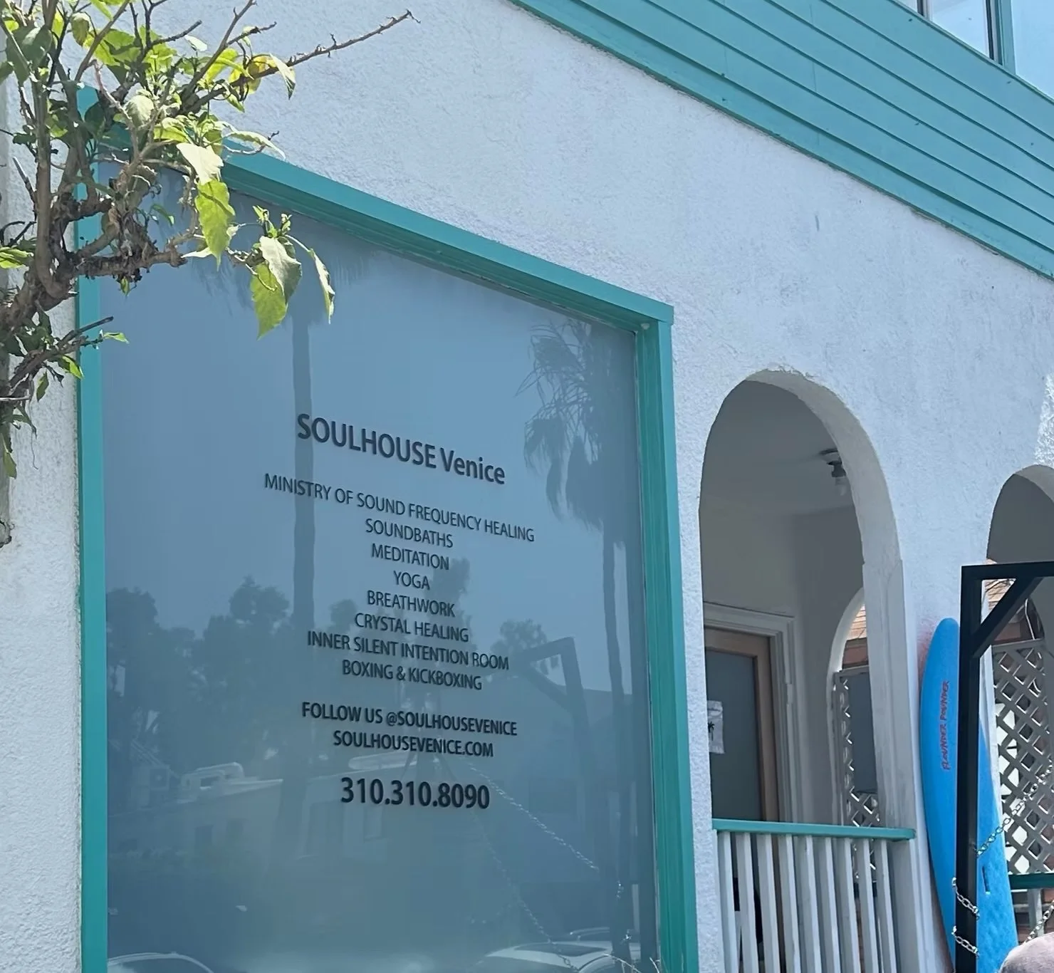 A bright blue storefront with the words SoulHouse Venice: Ministry of Sound Frenquency Healing, Soundbaths, meditation, yoga, breathwork, crystal healing, inner silent intention room, boxing and kickboxing. Follow us @soulhousevenice