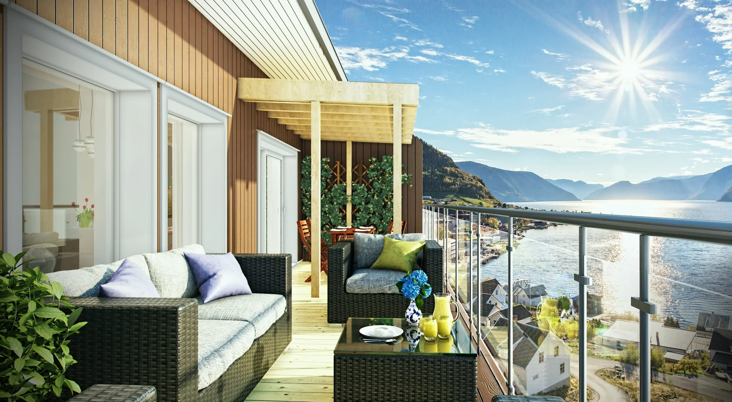 Terrasse med sofa, lenestol, blomsterpotter, utsikt over fjord og fjell