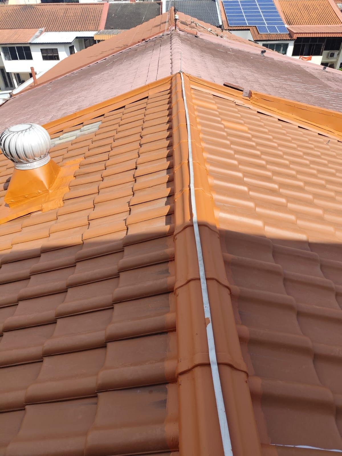 View of a tiled rooftop with solar panels and a ventilation pipe.