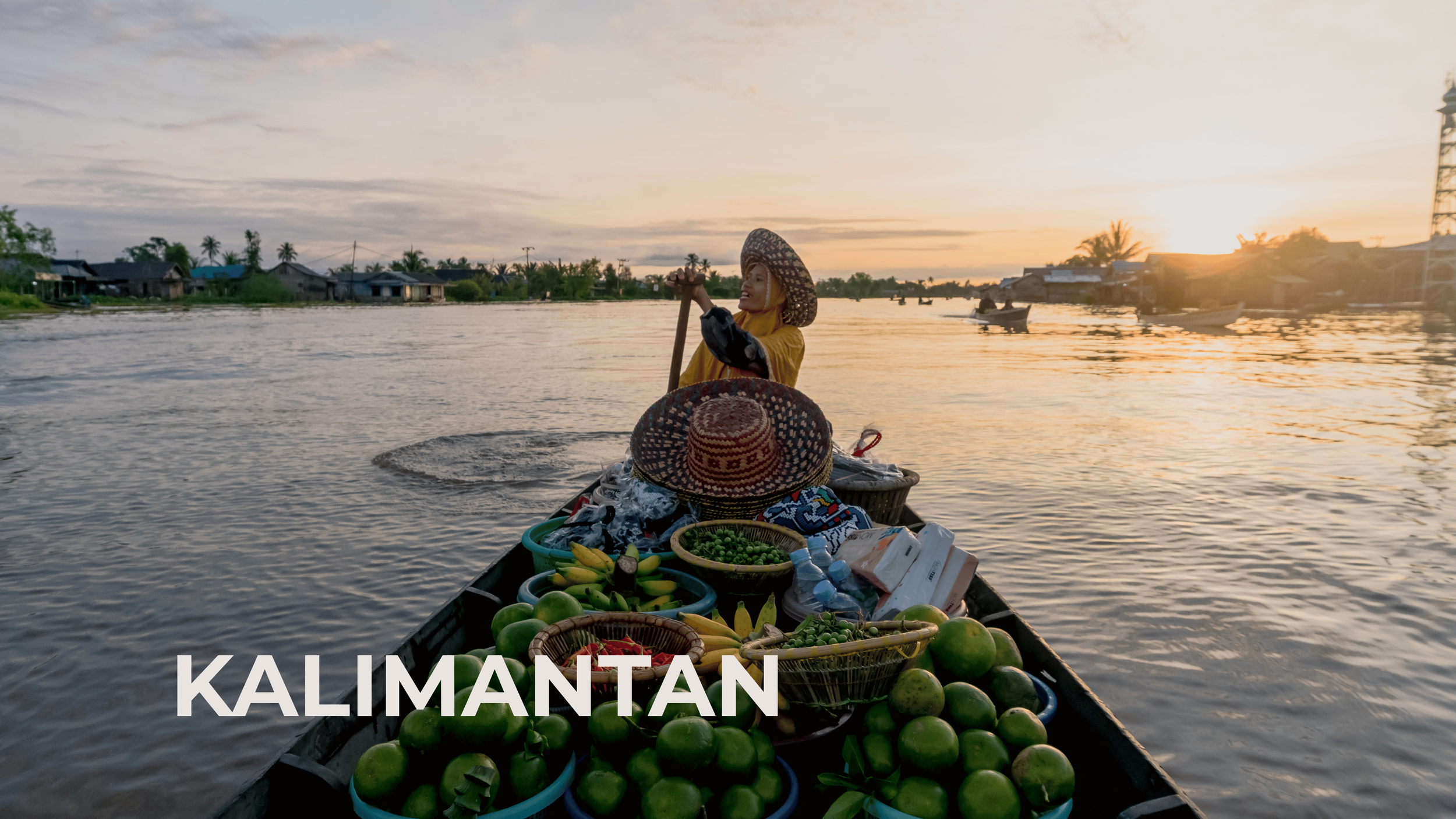 A woman in traditional attire paddling a boat filled with watermelons and other produce on a river during sunset in Kalimantan.