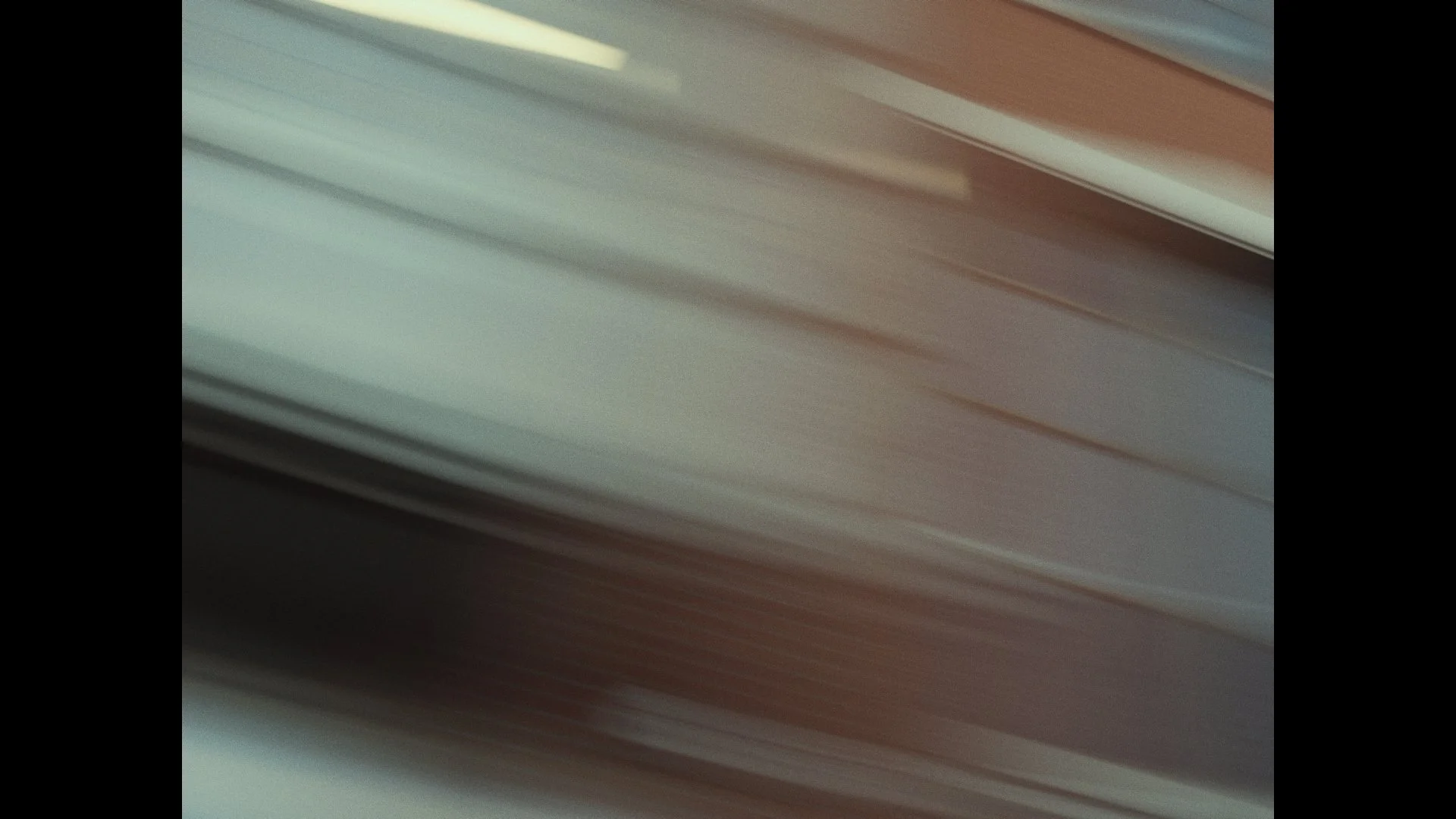 Blurred image of horizontal lines with shades of beige, cream, and gray.