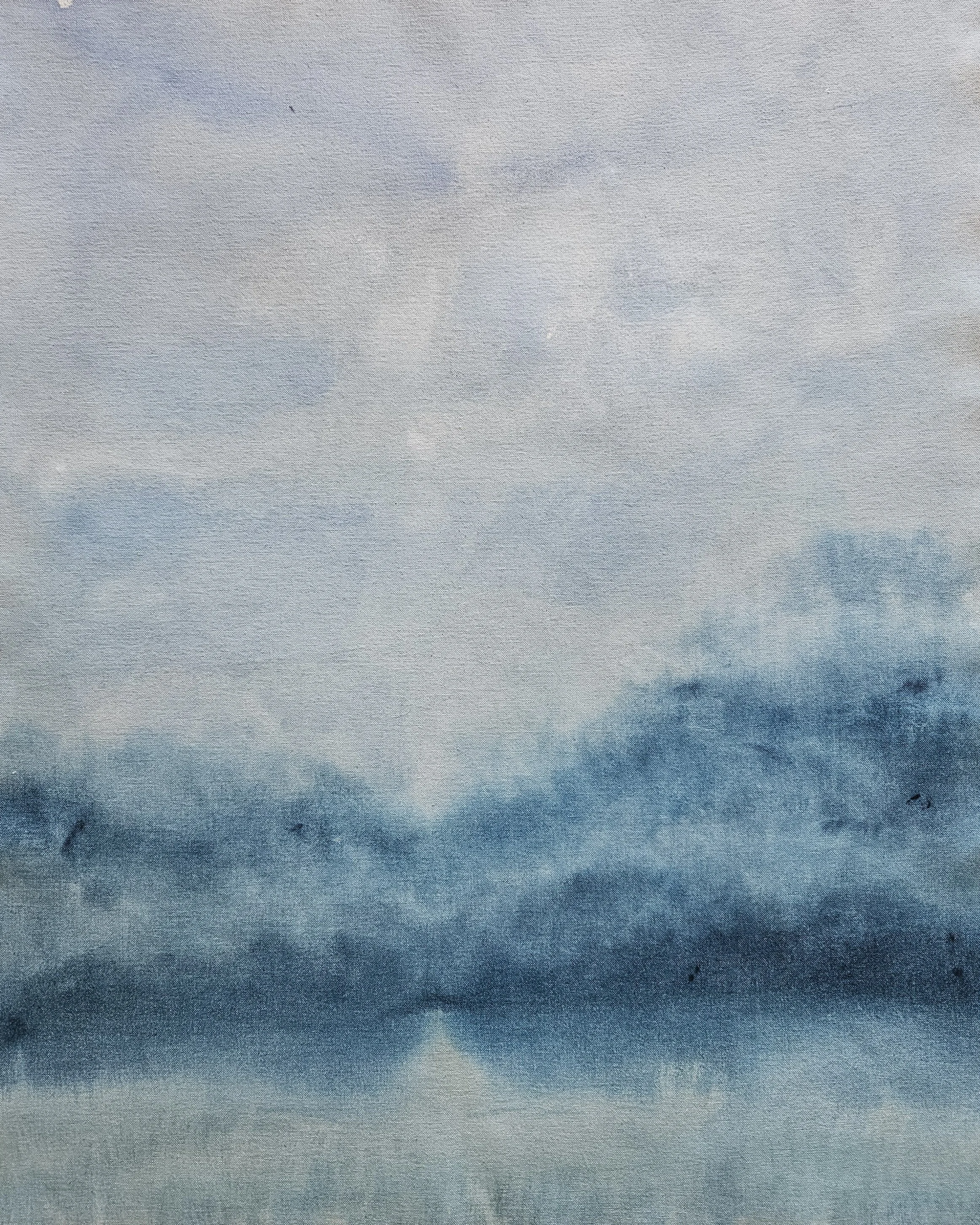 A gradient sky transitioning from light gray at the top to dark blue at the bottom. Landscape painting with light beaming through clouds.