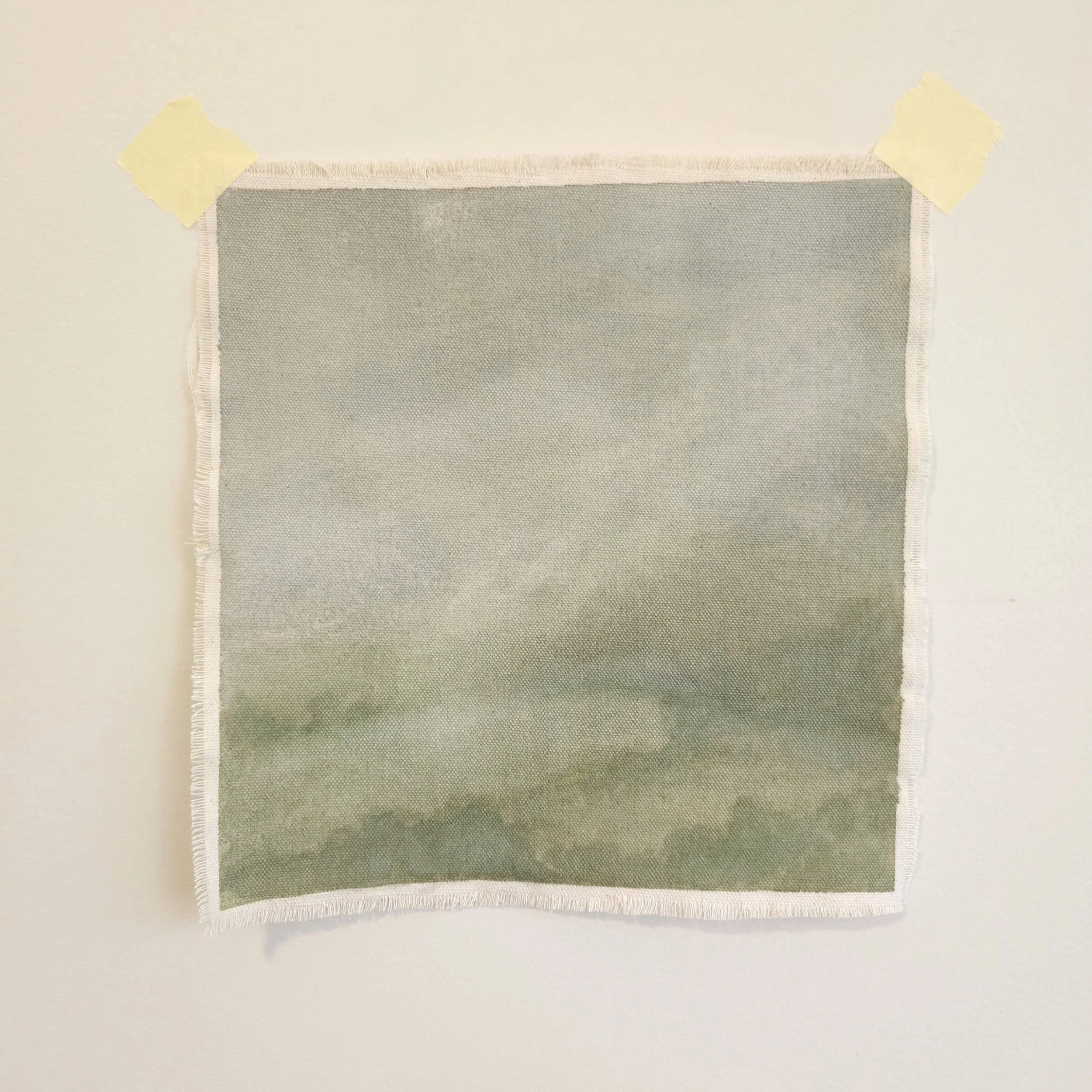 Soft and muted green toned landscape with raw cotton canvas and frayed edges. Atmospheric small landscape painting.