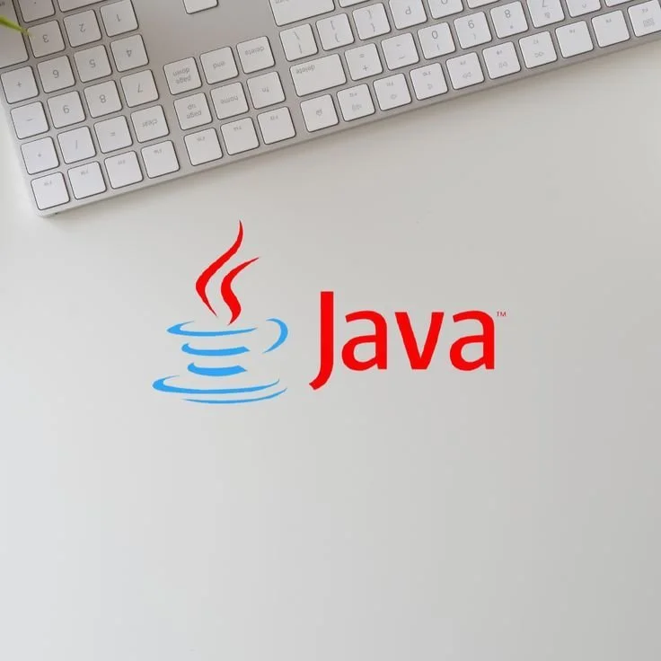 Java logo on a white surface with a computer keyboard nearby