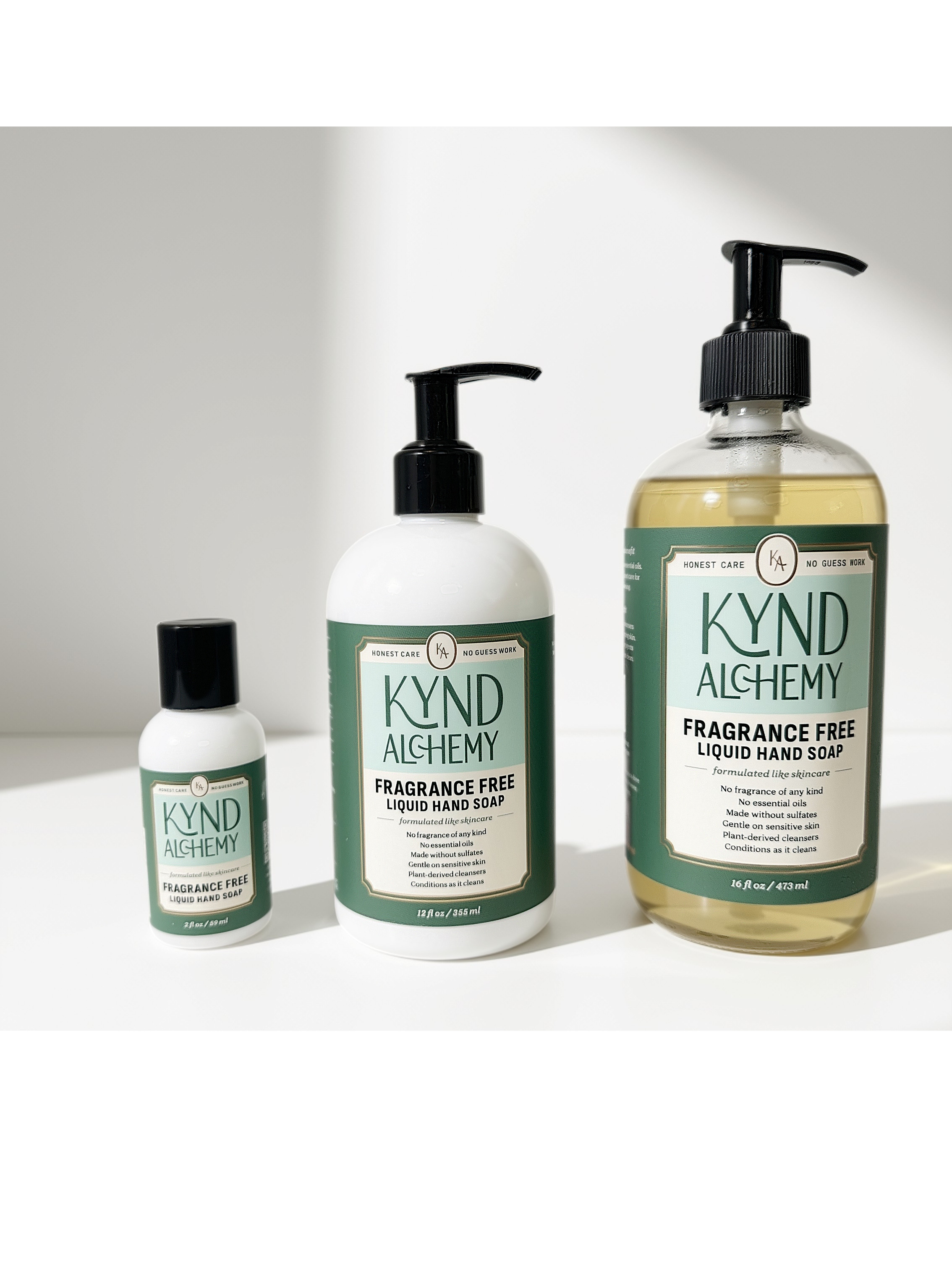 Kynd Alchemy fragrance-free hand soap in all three sizes — 2 oz, 12 oz, and 16 oz glass — side by side