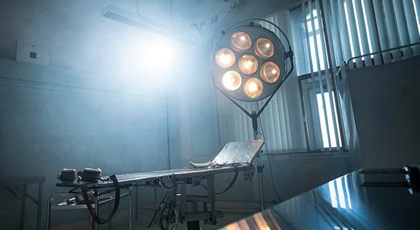 Moody production still from Abandoned, a found footage horror film, featuring an operating theatre central to the story.