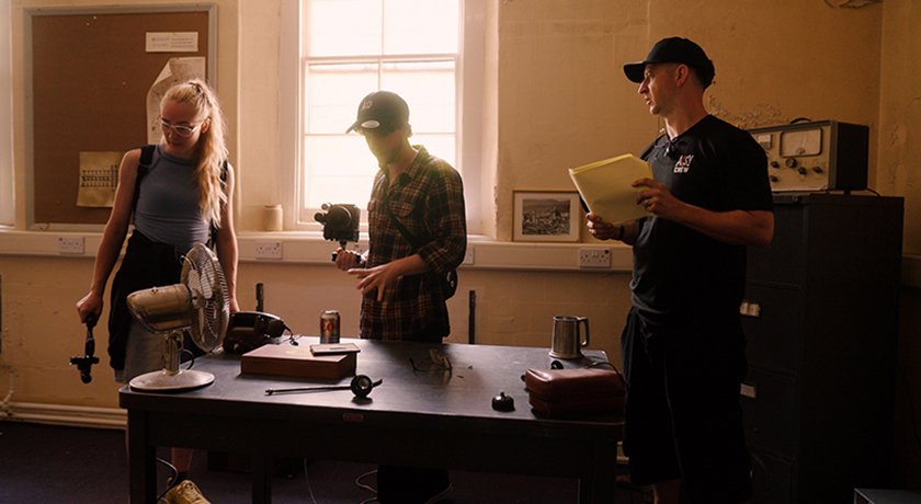 ⁠Production still from the rehearsal process of Abandoned, showing director and cast rehearsing a scene in this found footage horror film.