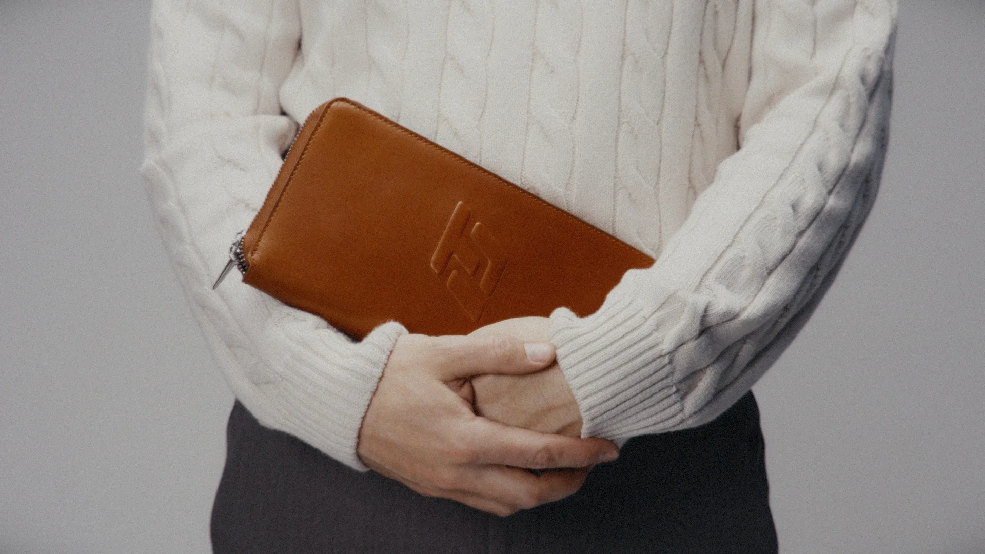 The Glove Wallet shown close-up to highlight its full-grain leather and embossed logo.