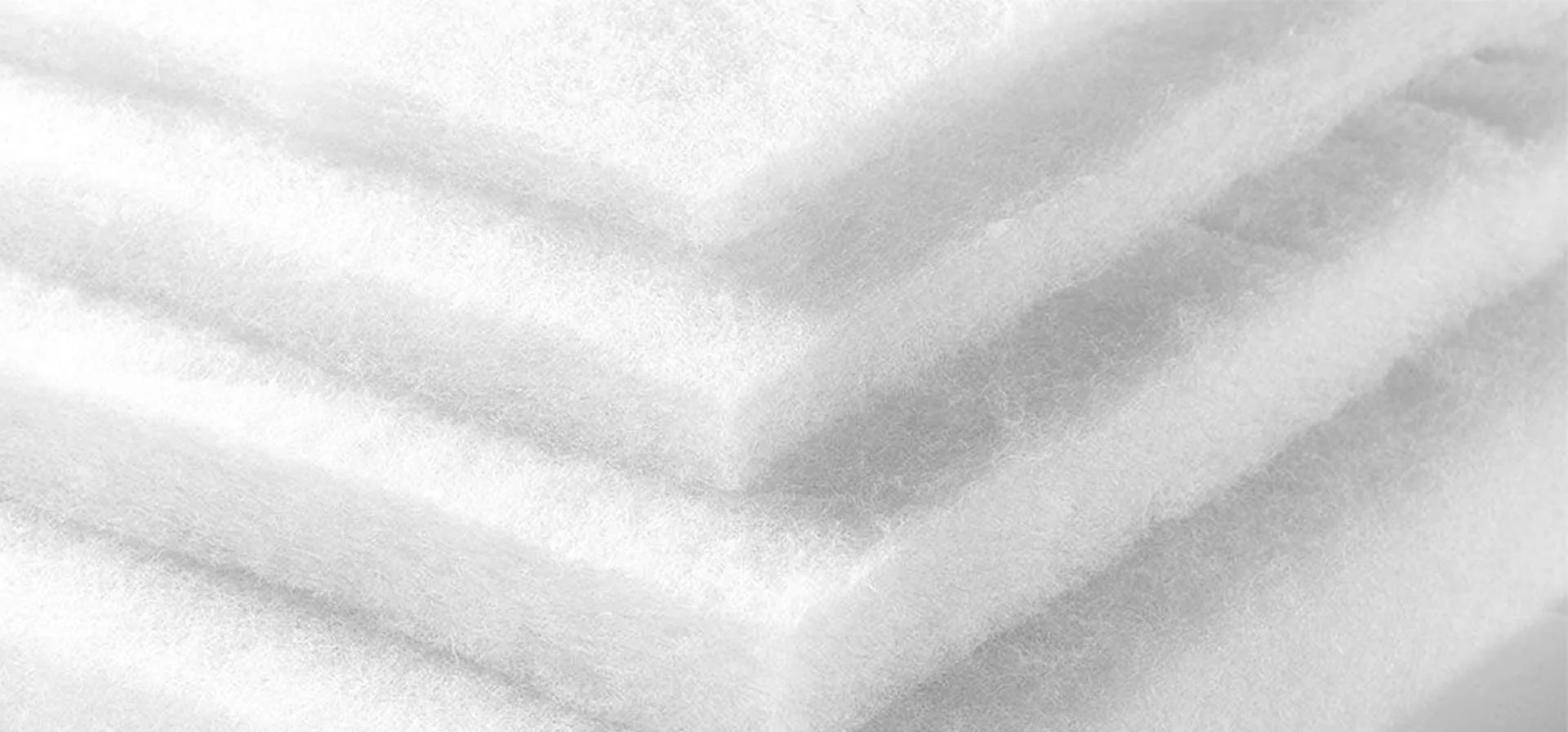 Close-up of a textured fabric with a soft, cloudy appearance in shades of gray.