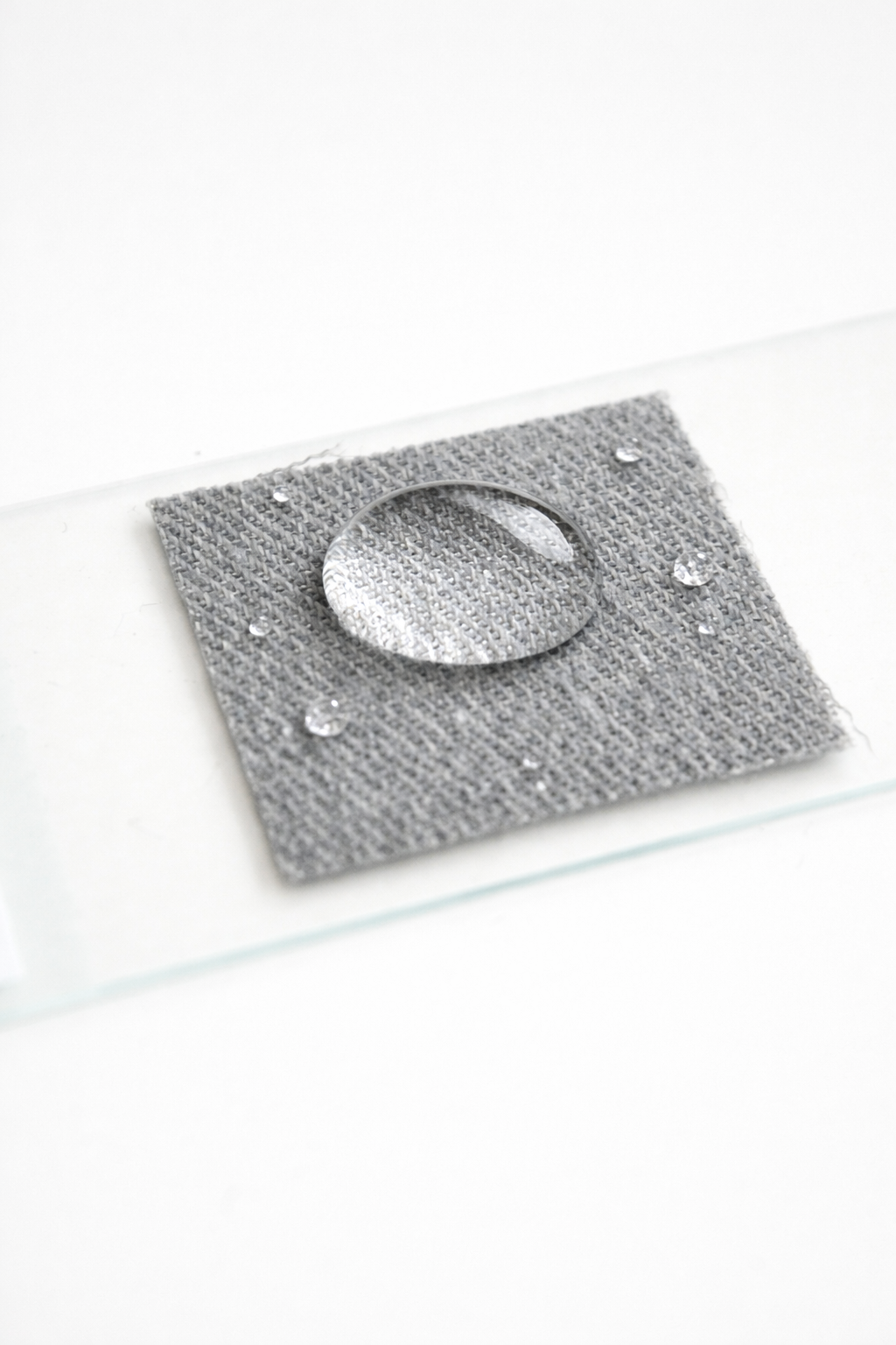 a sample of grey mpower suiting fabric showing water repellency.