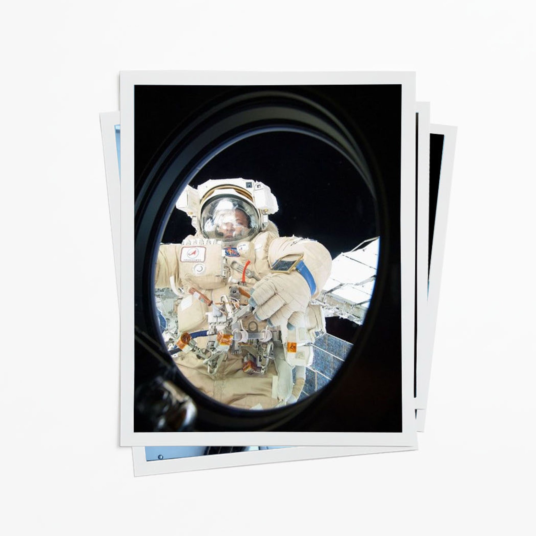 Astronaut in spacesuit takes a selfie in space, visible through the Internation Space Station (ISS) window with Earth in the background.