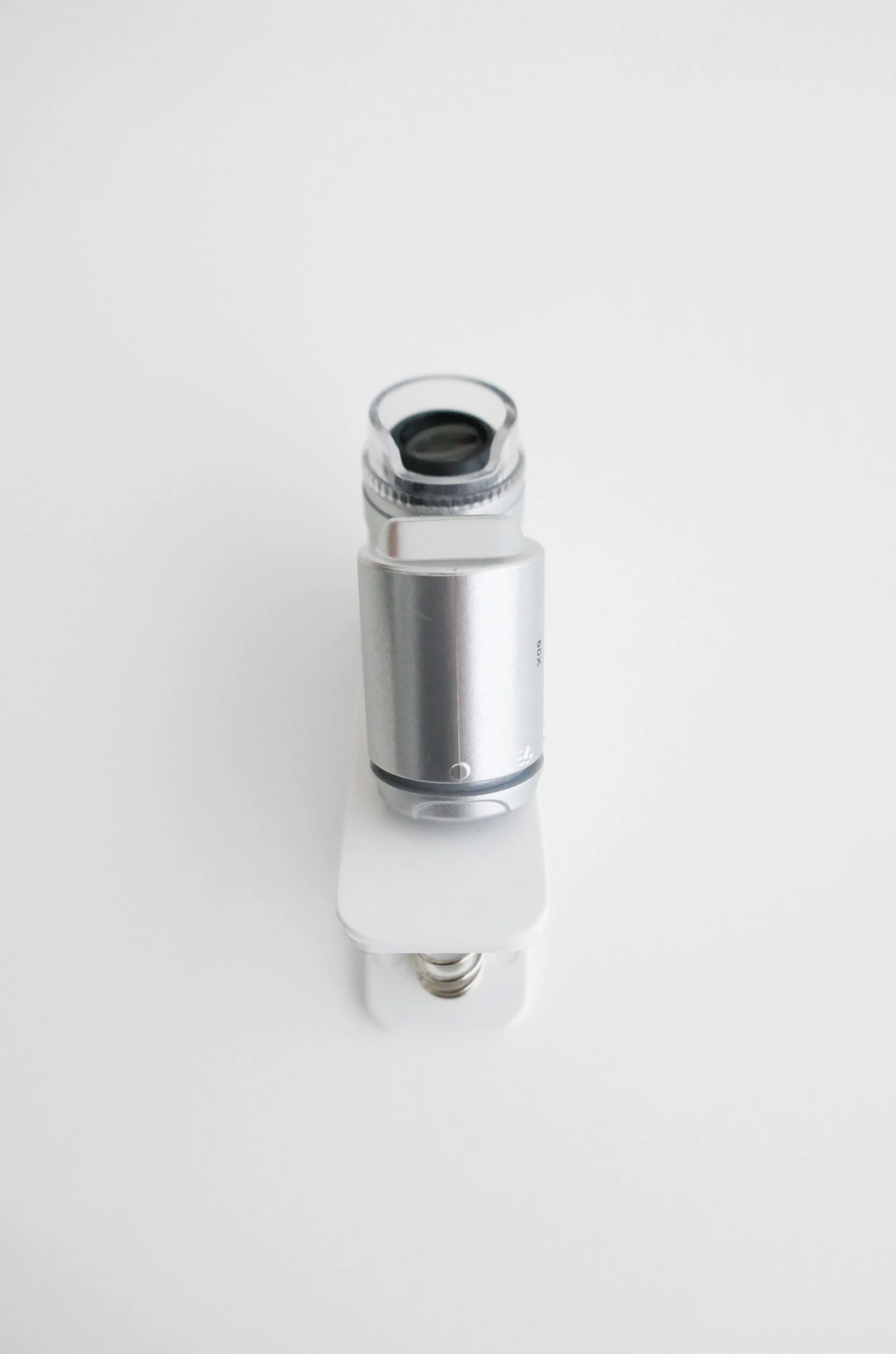 A vape device laying on a white surface.