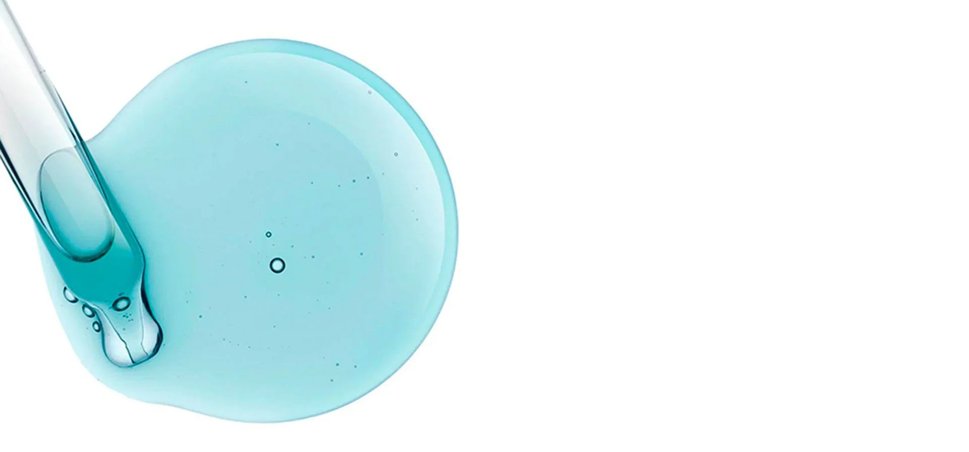 Close-up of a blue liquid droplet with a pipette.