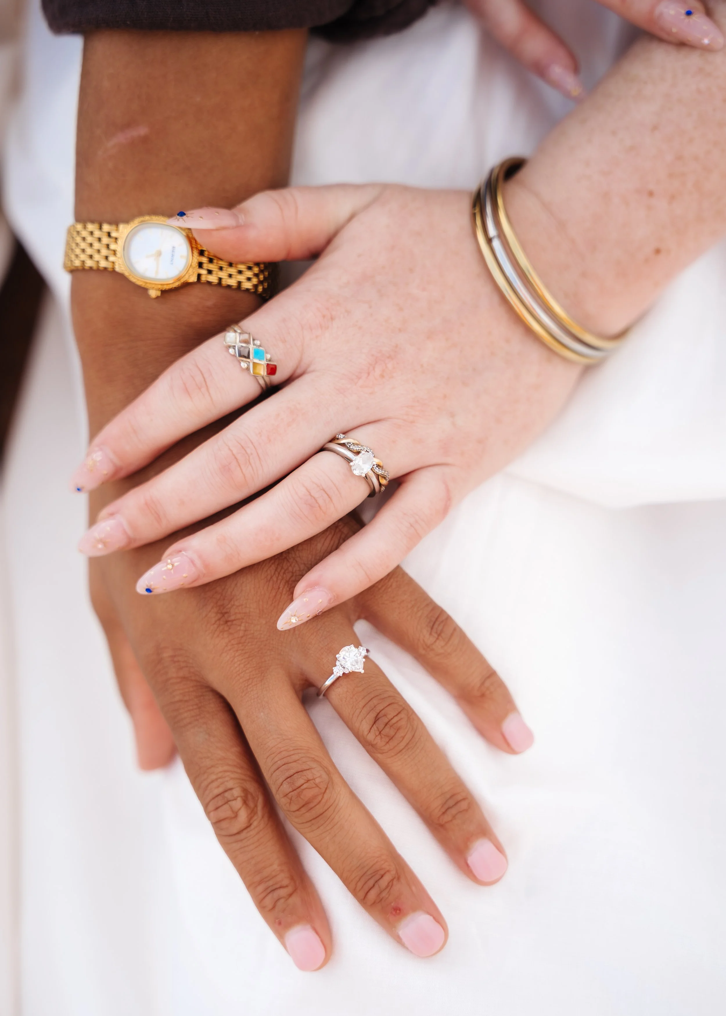 Close-up of hands displaying rings and jewelry during their couples photography session.