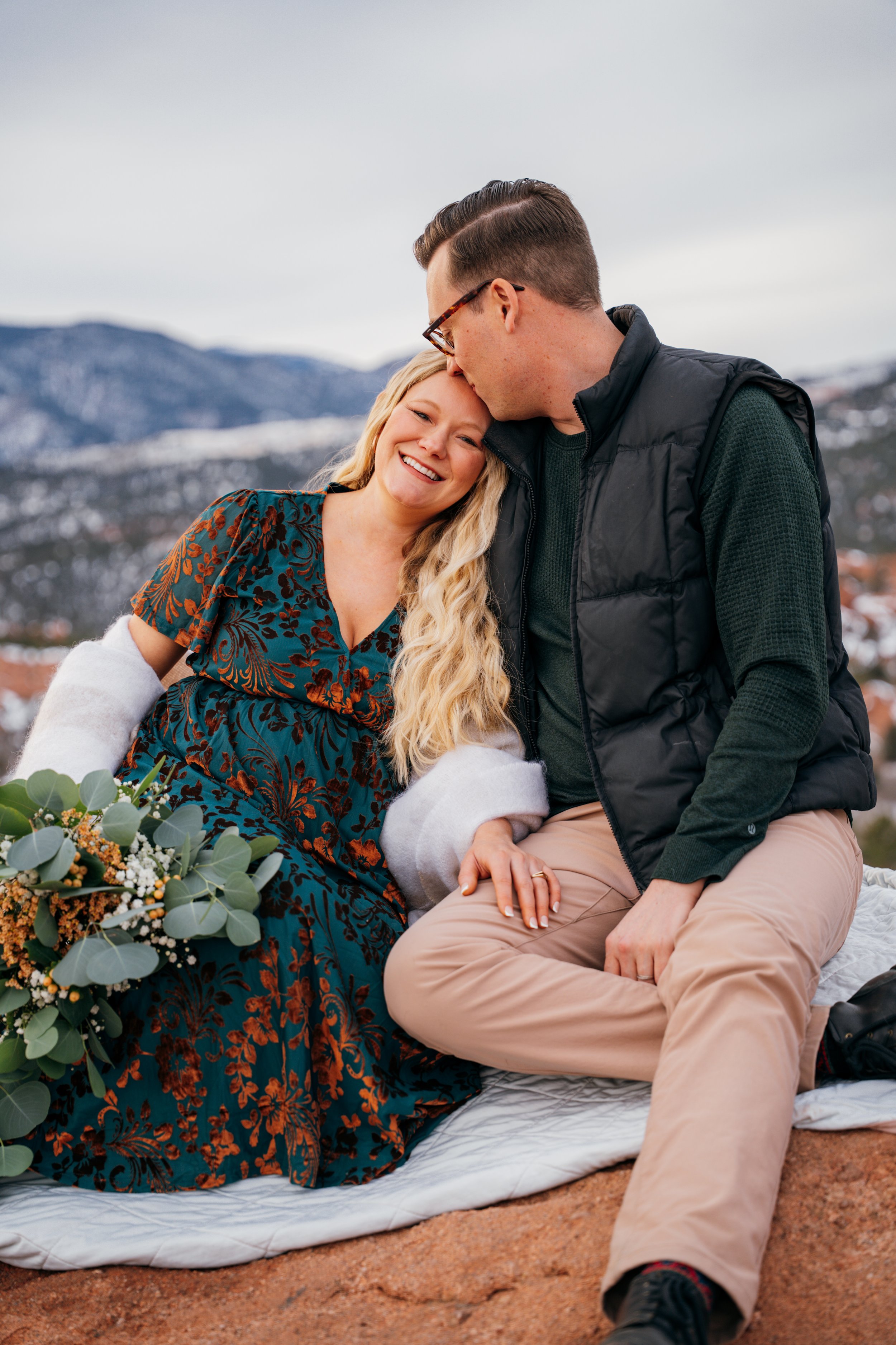 Close-up of couple sharing a quiet moment during a winter maternity session outdoors in Colorado Springs