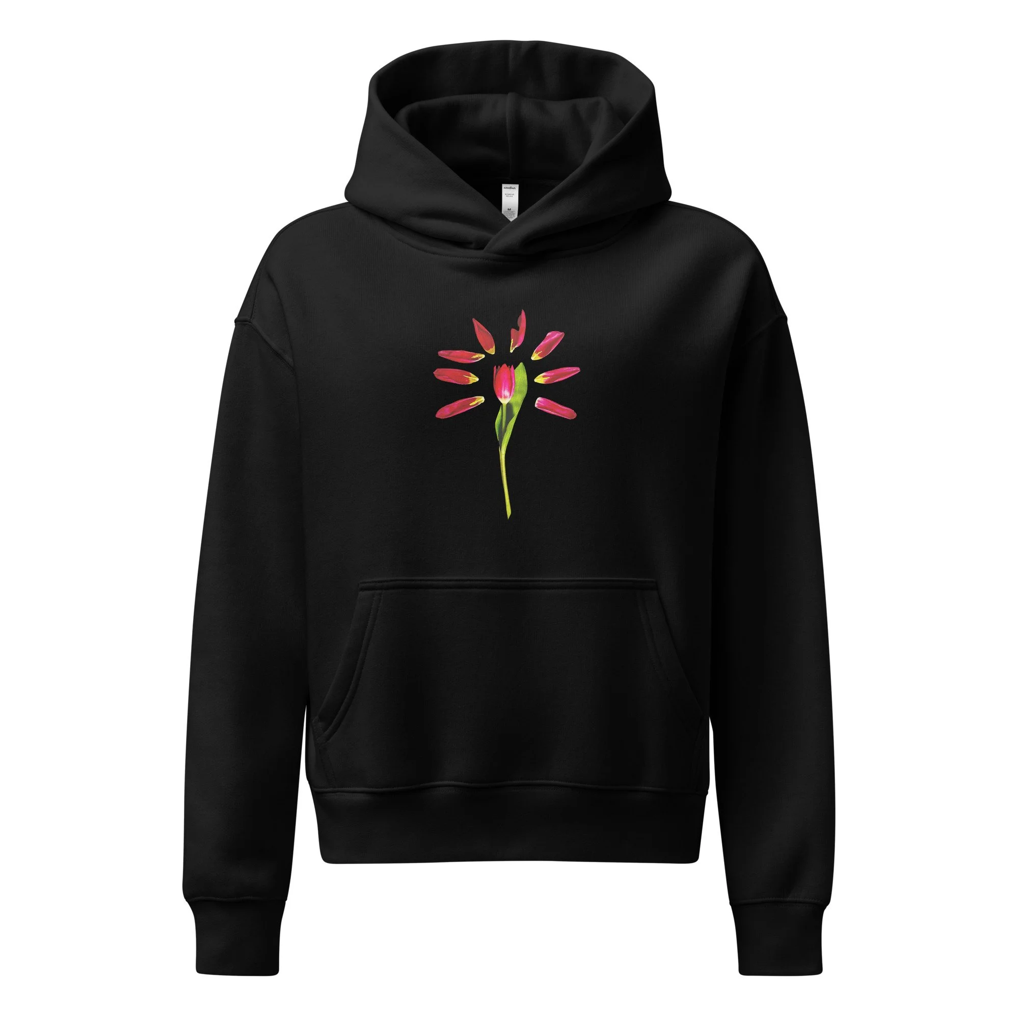 Black hoodie featuring centered minimalist tulip artwork with red and yellow bloom and green stem, photographed from Bone Bloom & Rust studio still life series.