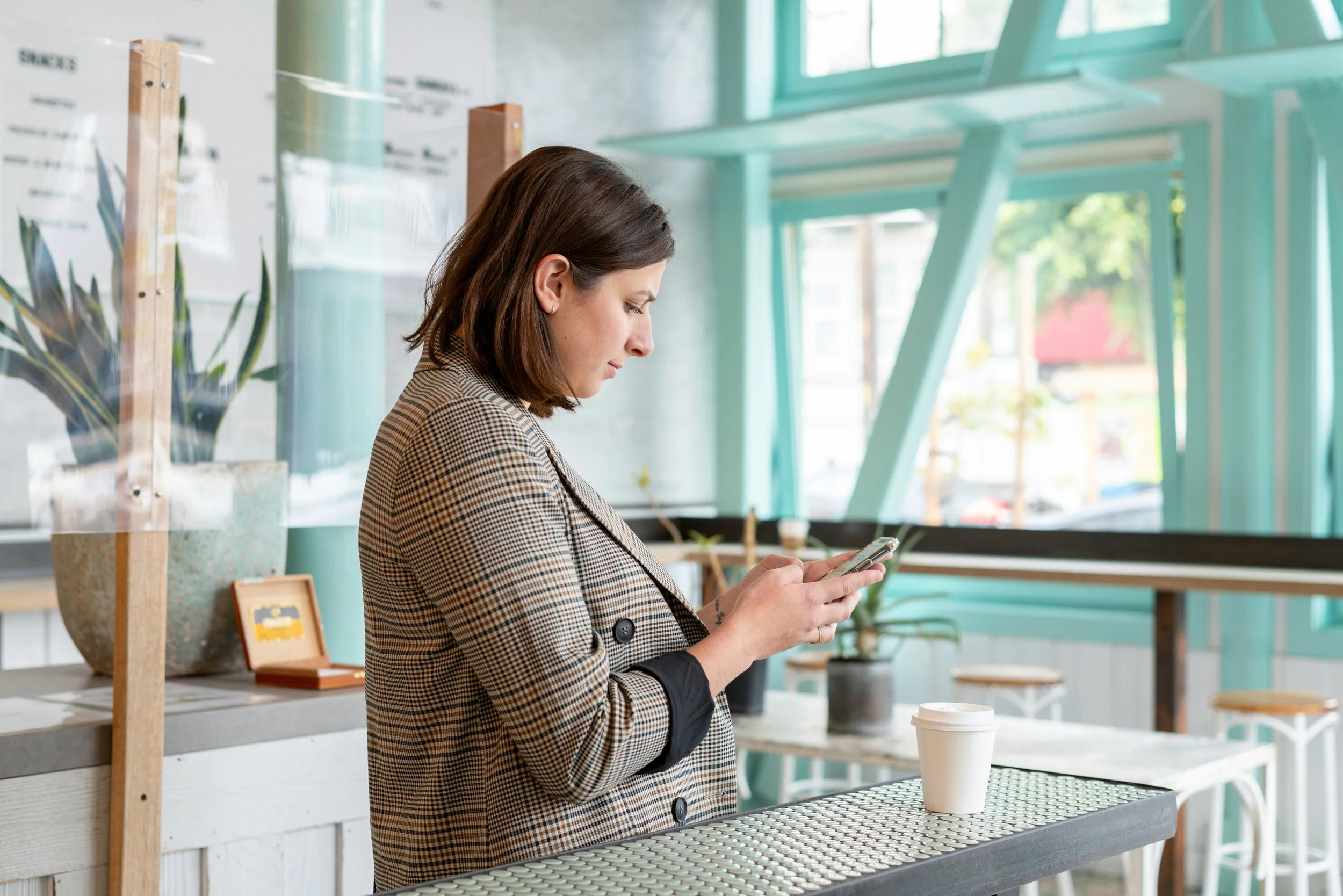 Black rotary dial telephone with a coiled cord on a white background
