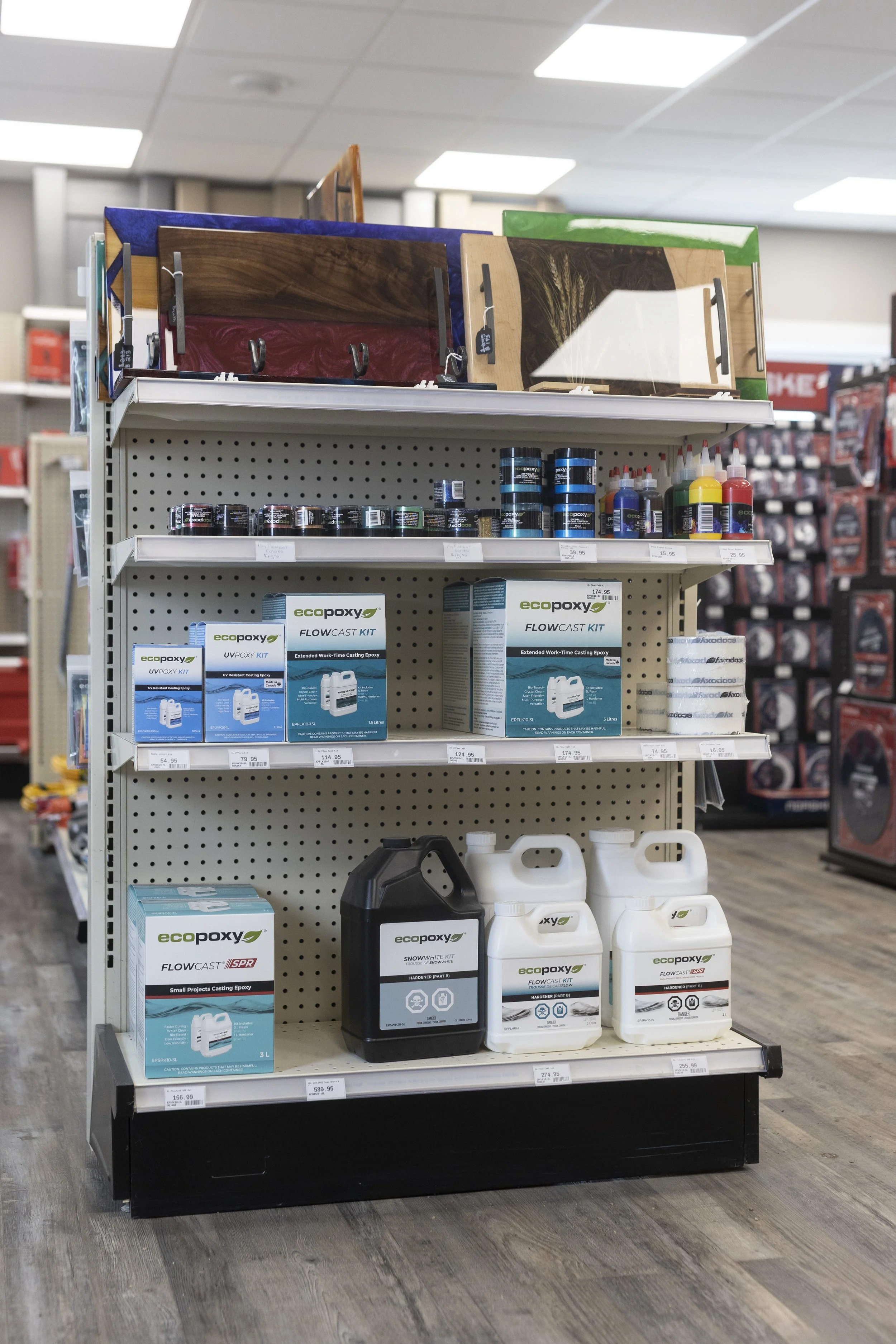 Display of various epoxy resins and related products on a store shelf.