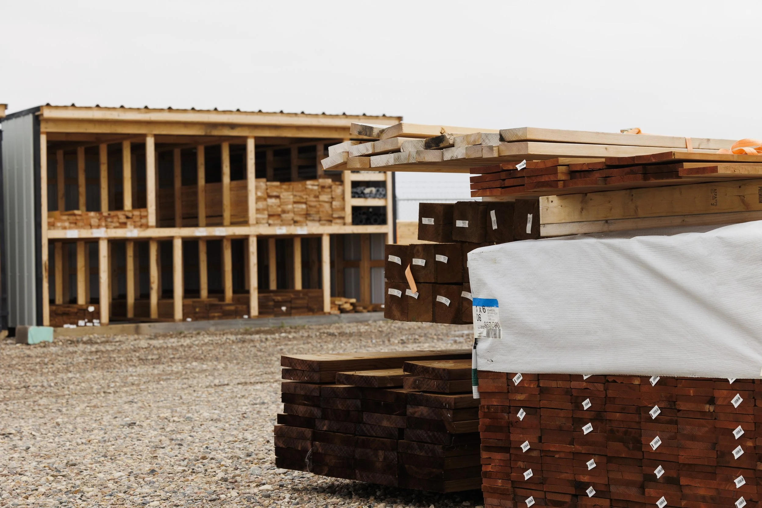 Stacks of lumber and wooden planks in an outdoor construction materials yard