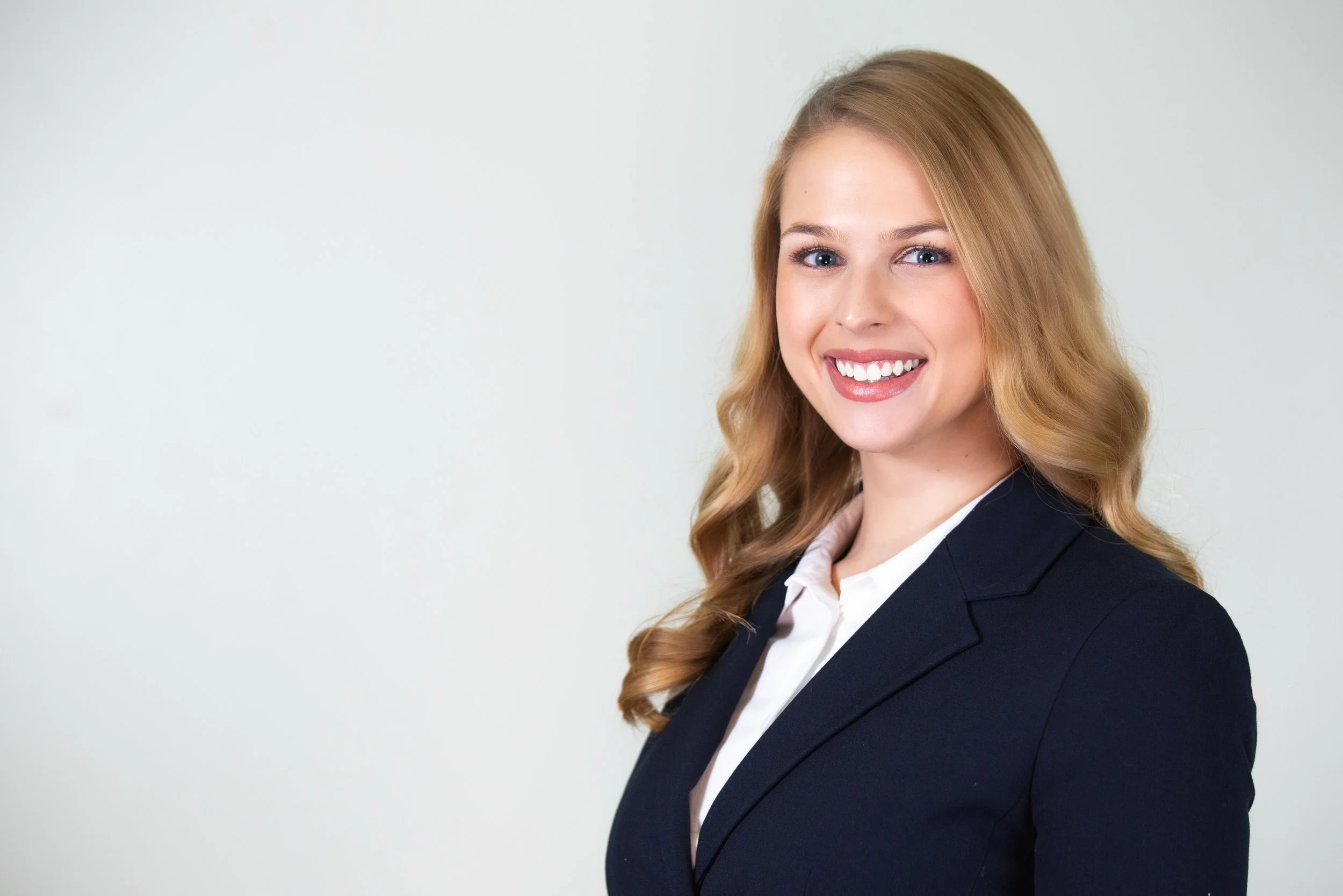 Brittany Ranieri, D.O. Psychiatrist specializing in integrative mental health and reproductive psychiatry. Professional woman with blonde hair, smiling, wearing a navy blazer and white shirt, against a plain light background.