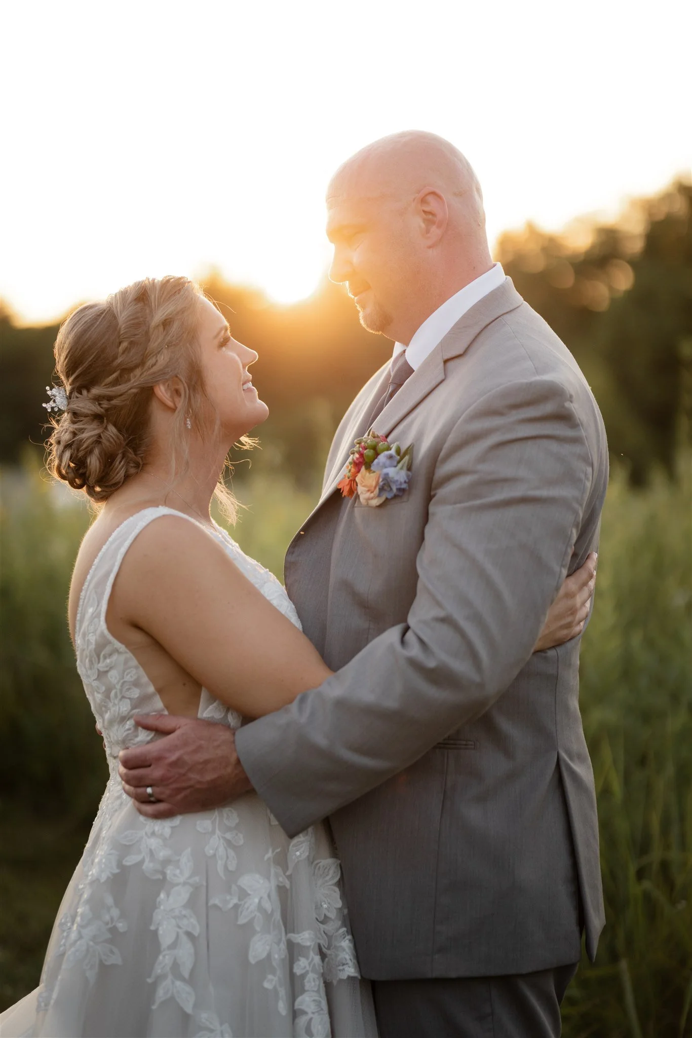 Laurie’s customers, Fernando and Kate embracing by the lake on their wedding day.