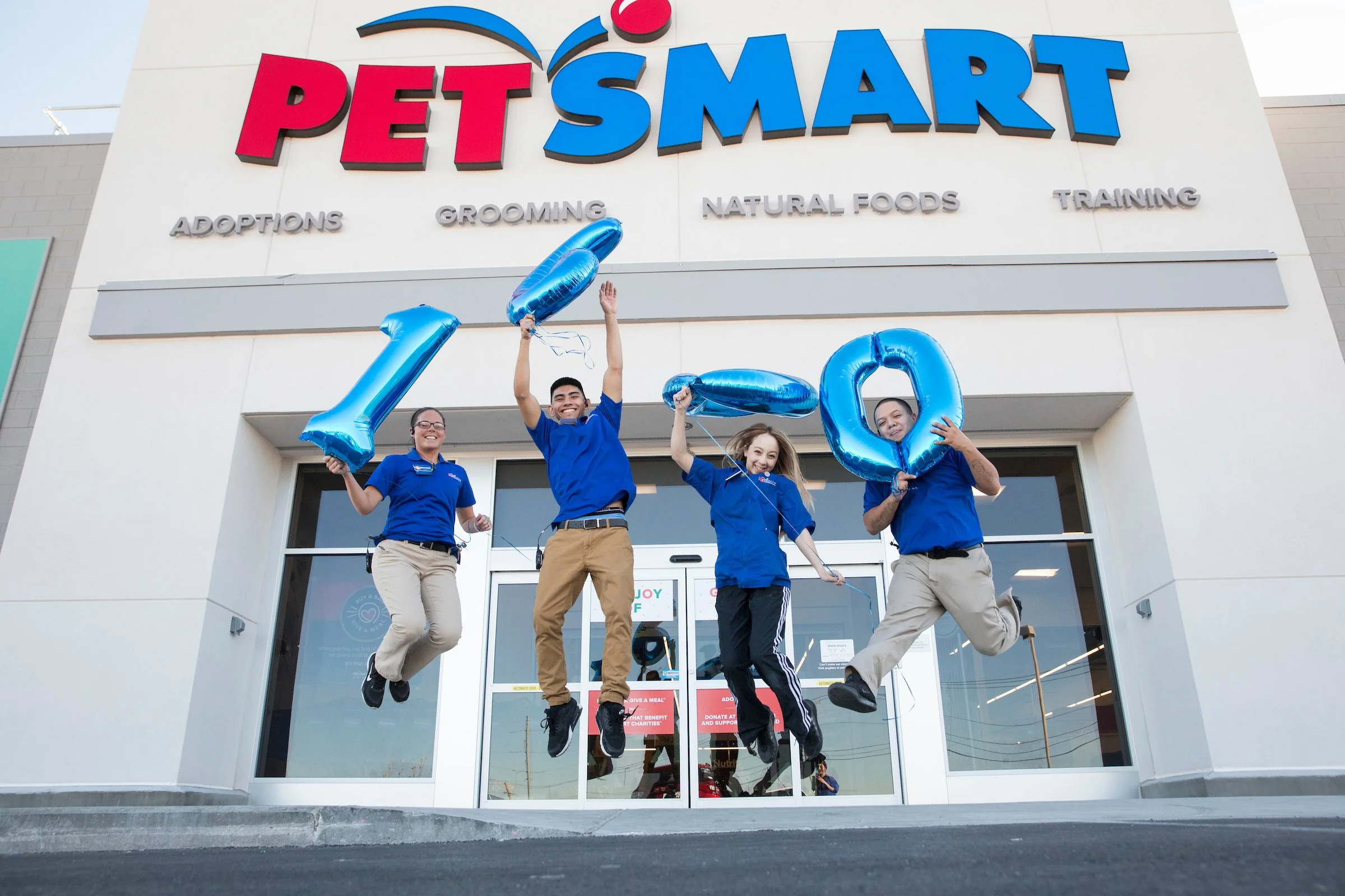 PetSmart Store Front with happy PetSmart associates jumping.