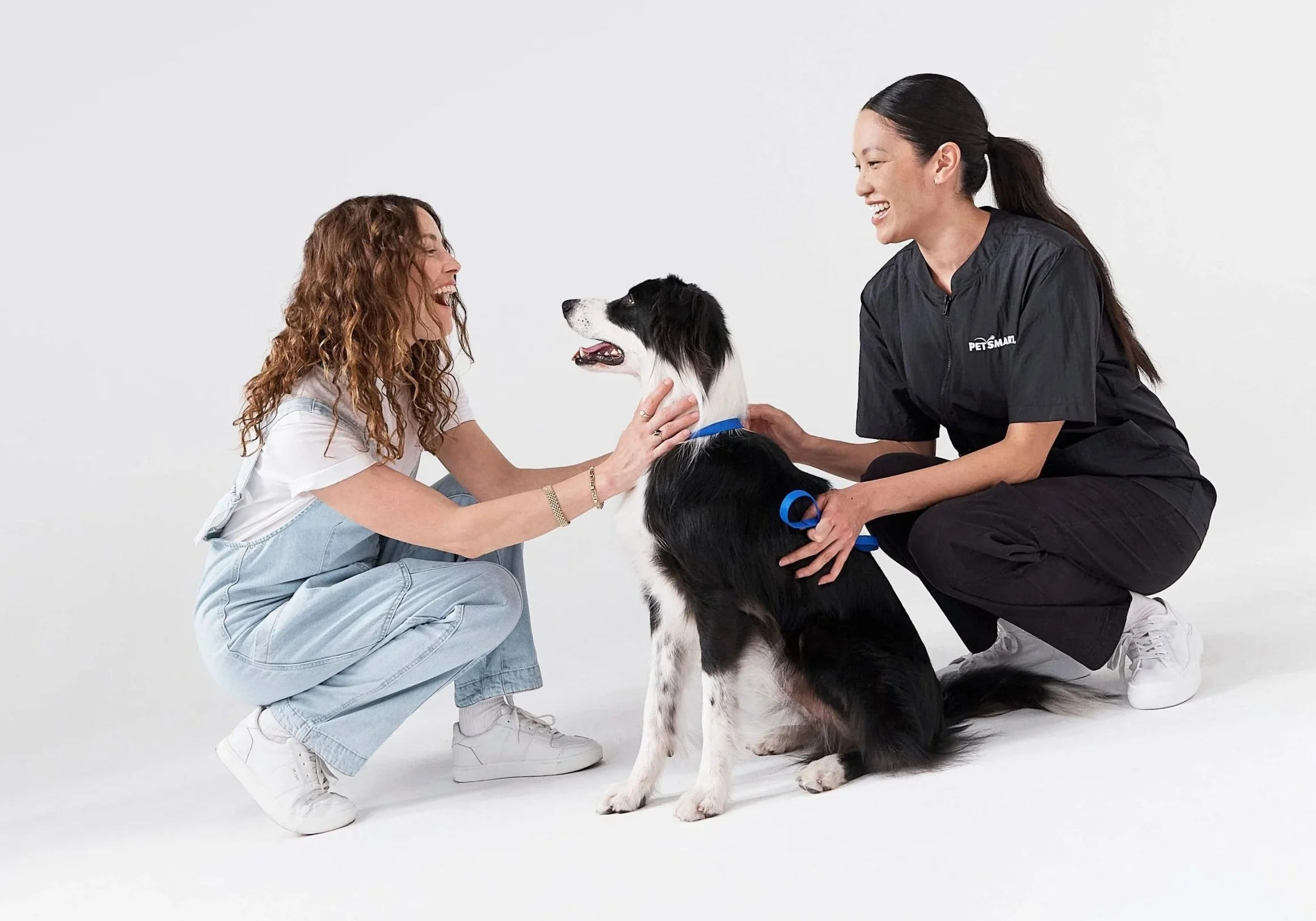 Pet Parent and their dog with a PetSmart Pet GroomingStylist