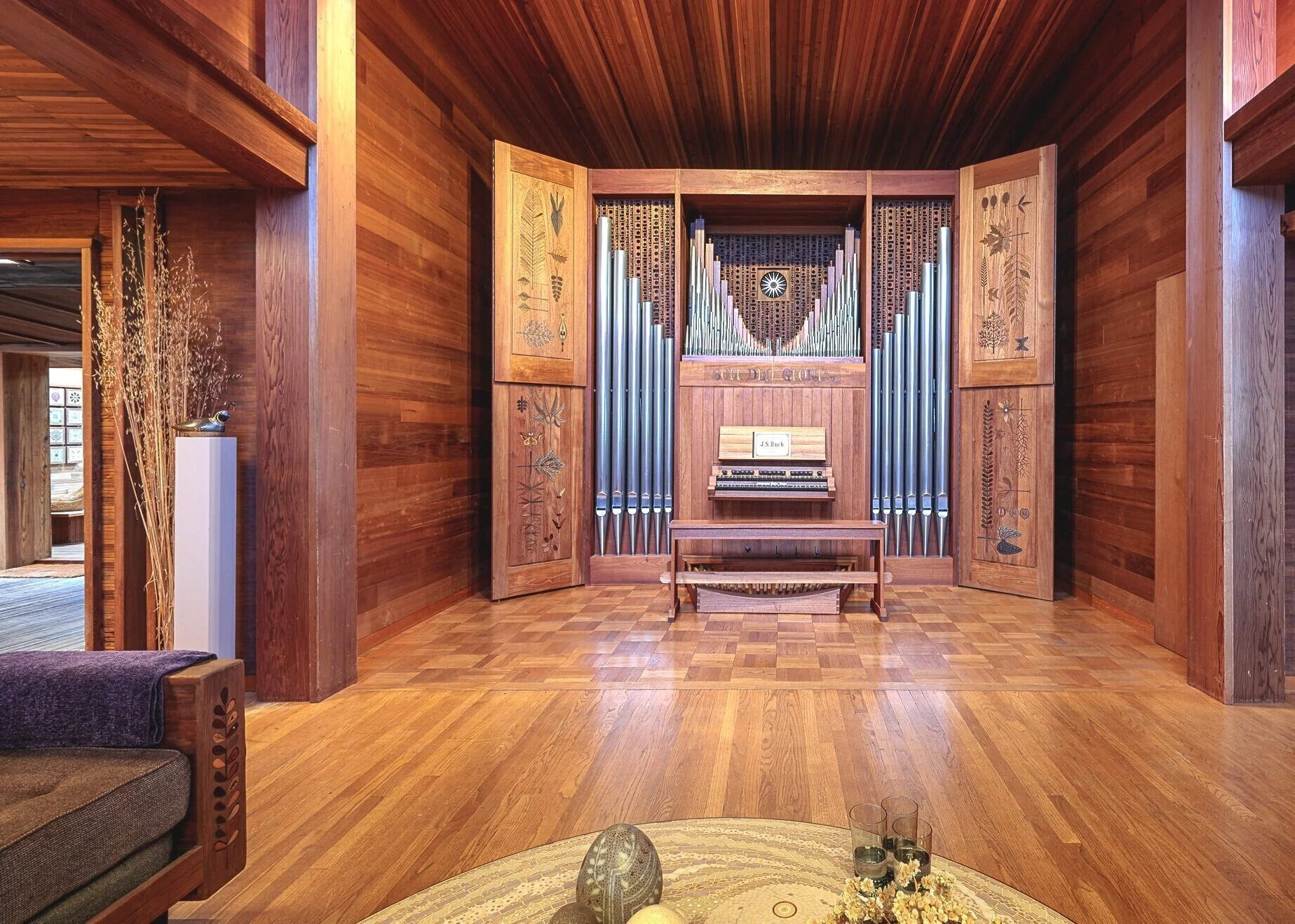 An organ instrument in an artistic wood paneled room