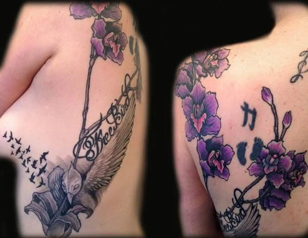 Close-up of two people's shoulders with tattoos including purple flowers, birds, and Asian characters.