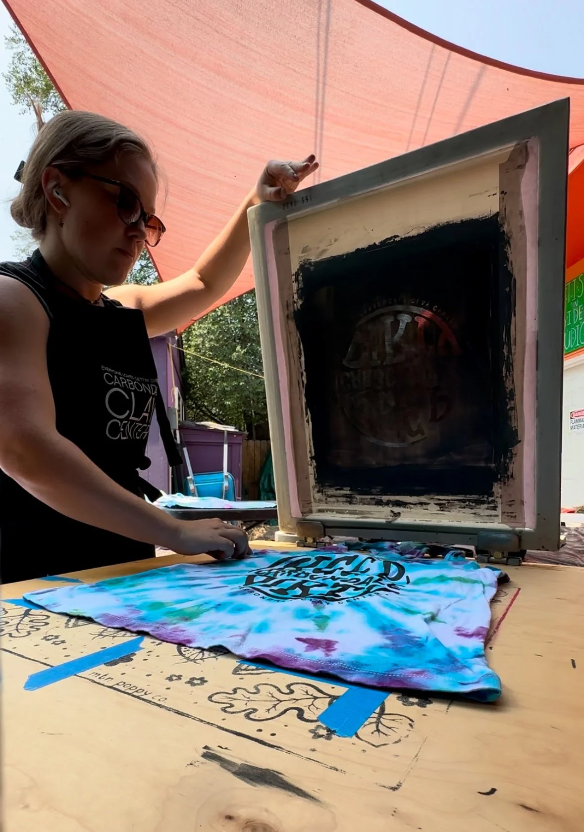 Screenprinting my design onto tie-dyed shirts for CCC.