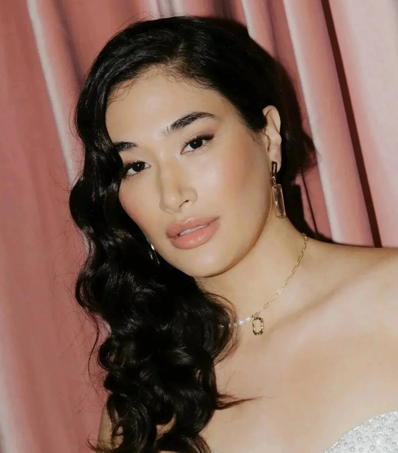 Soft glam bridal makeup with dewy finish, defined brows, and cascading curls – luxury bridal beauty look.