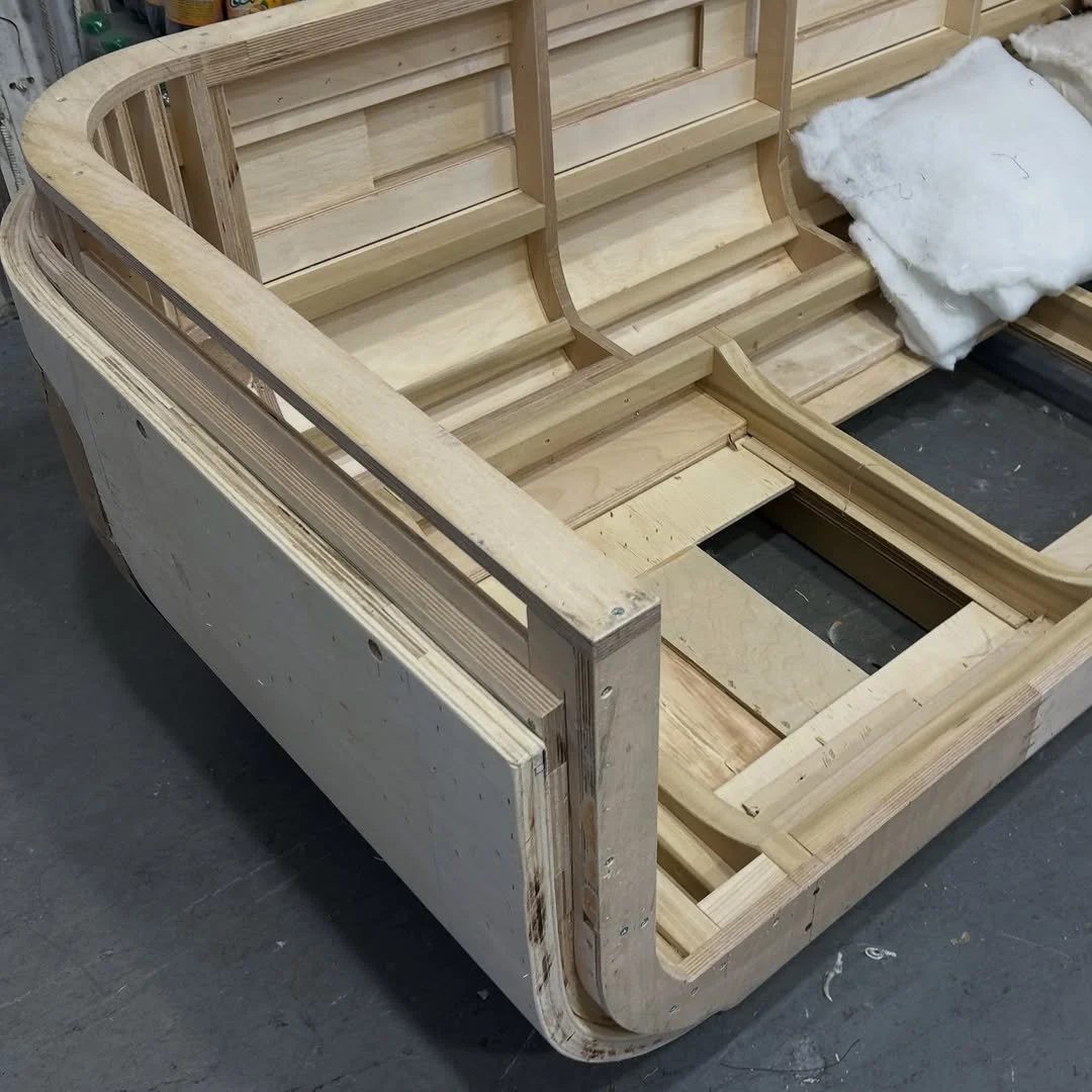 This is the frame structure of a custom curved sofa coming to life in our workshop. After refini.jpg