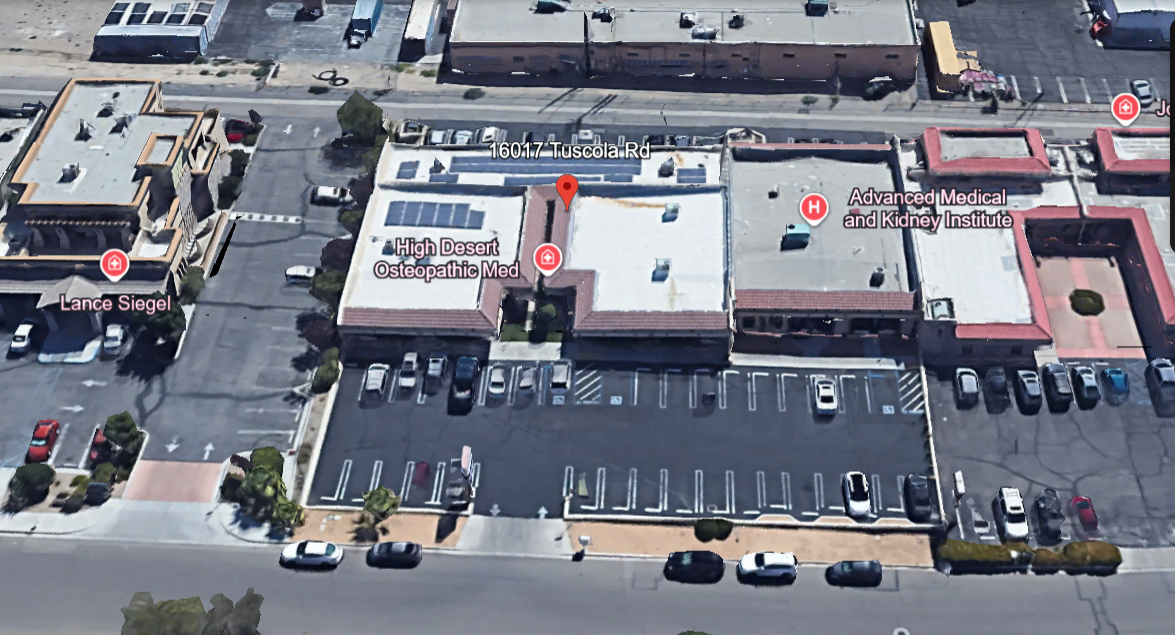 Aerial view of medical facilities, including High Desert Osteopathic Medicine and Advanced Medical and Kidney Institute, with parking lot and surrounding buildings.