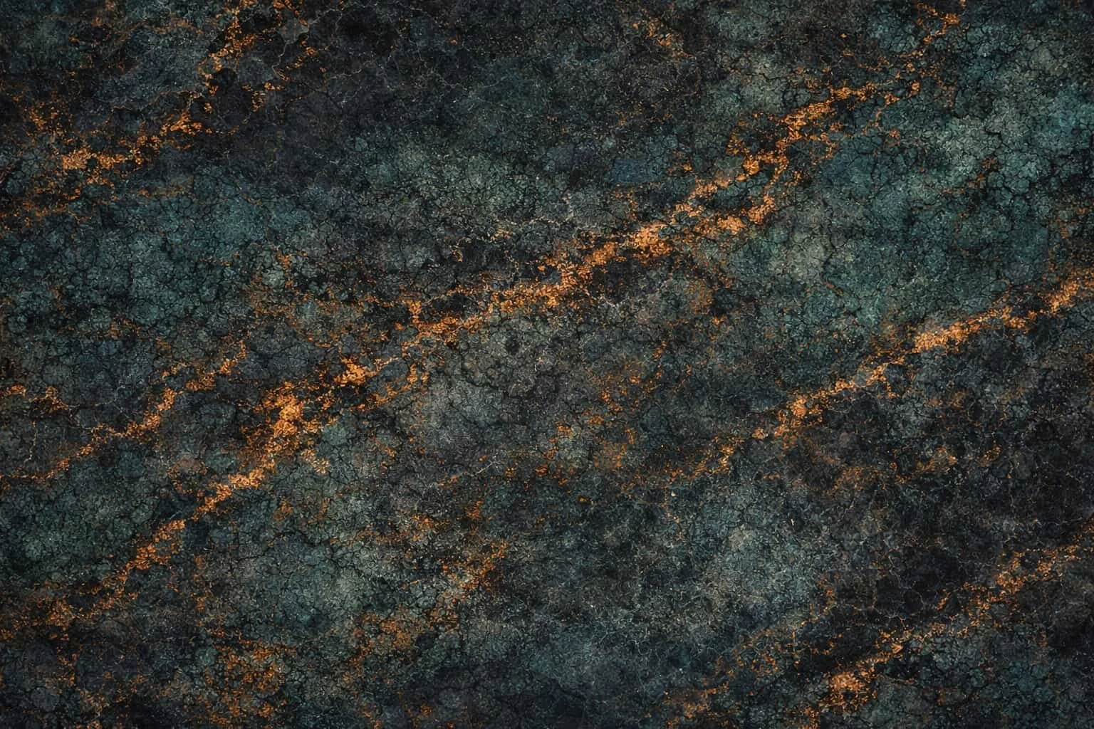 Close-up of dark, cracked surface with orange and black tones.