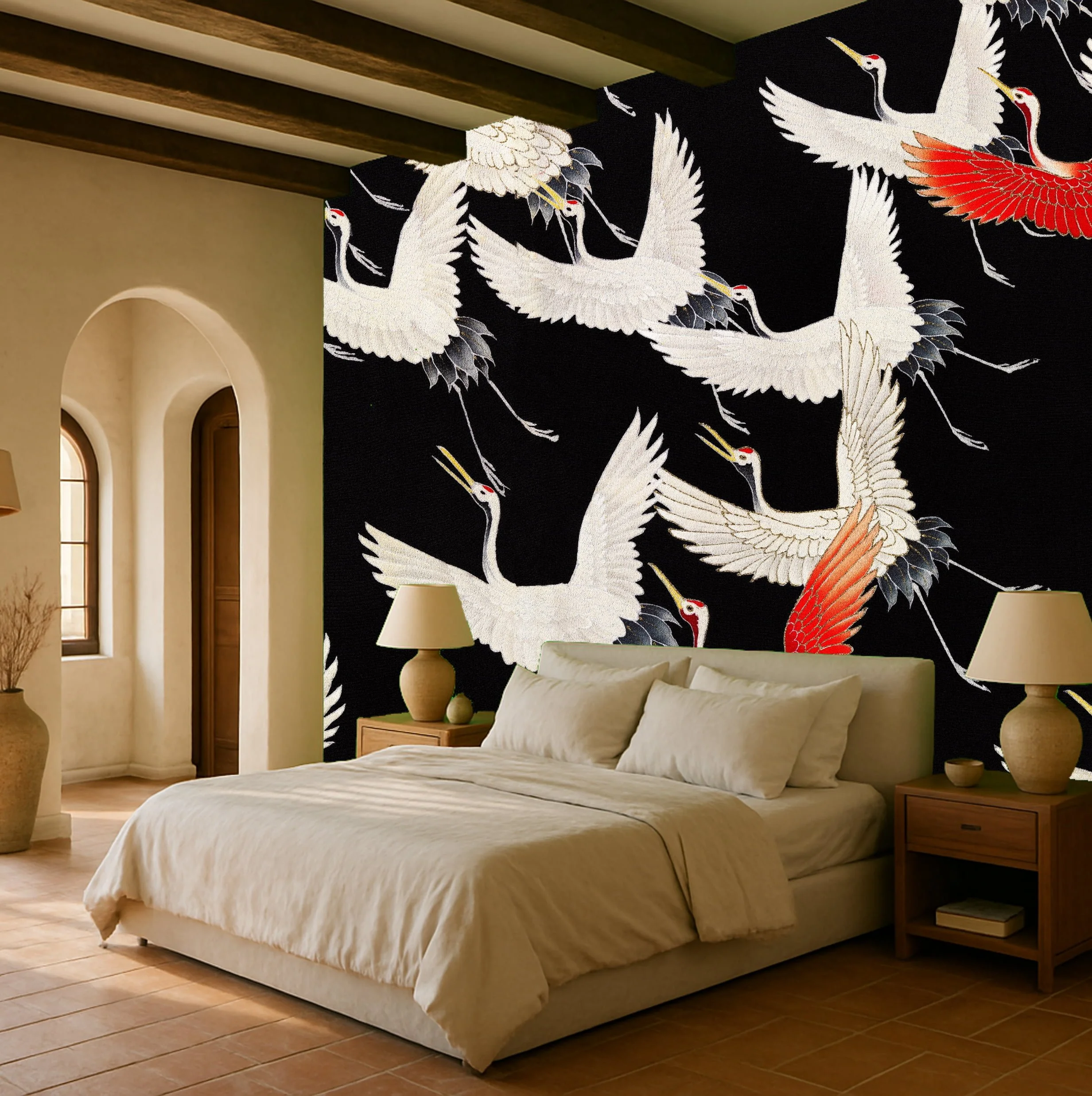 A bedroom with a large black wall featuring a pattern of white and red cranes in flight, two beige nightstands with lamps, a beige bed with pillows, and arched windows with natural light.