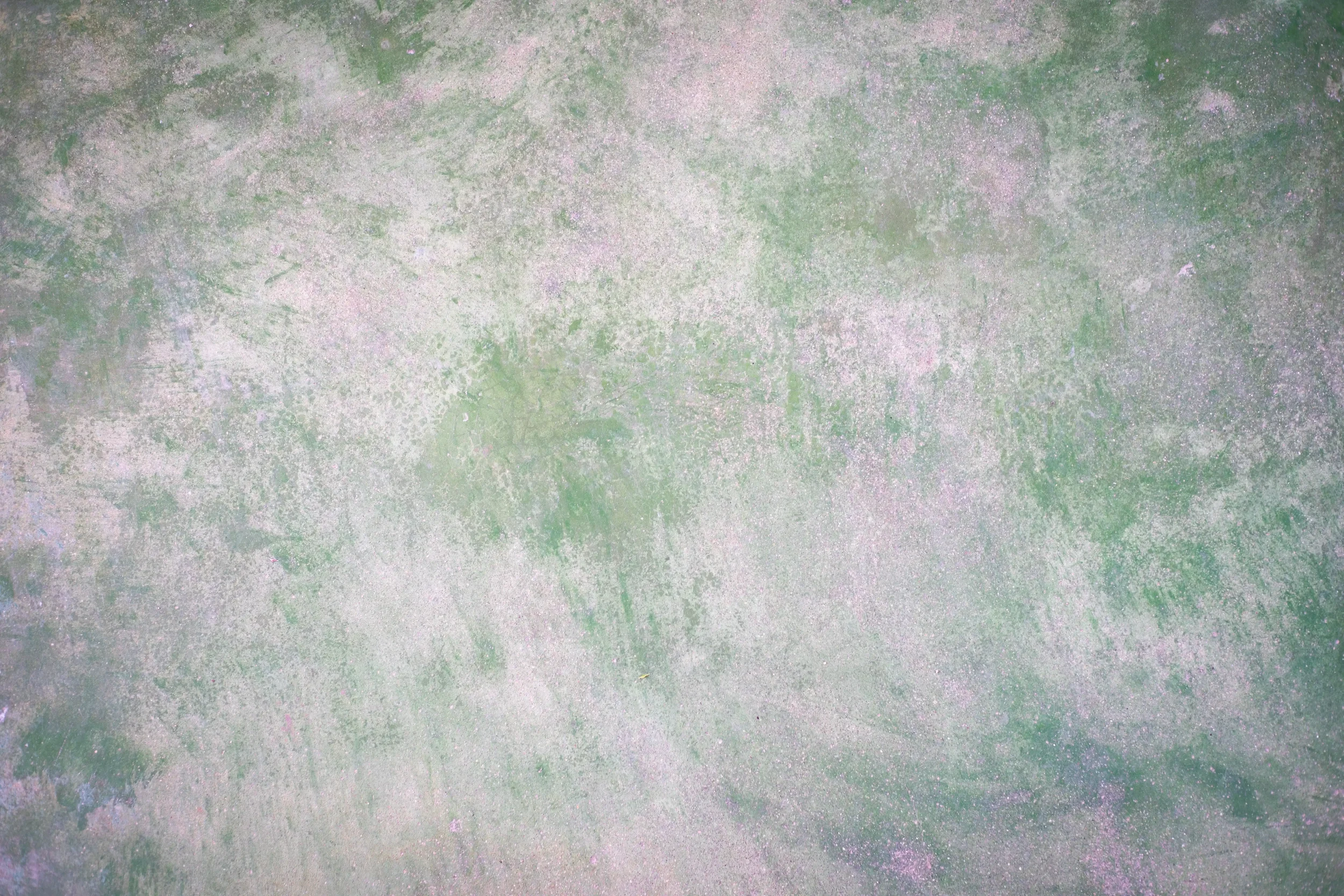 Abstract texture with shades of green, pink, purple, and white, resembling a watercolor painting or cosmic nebula.