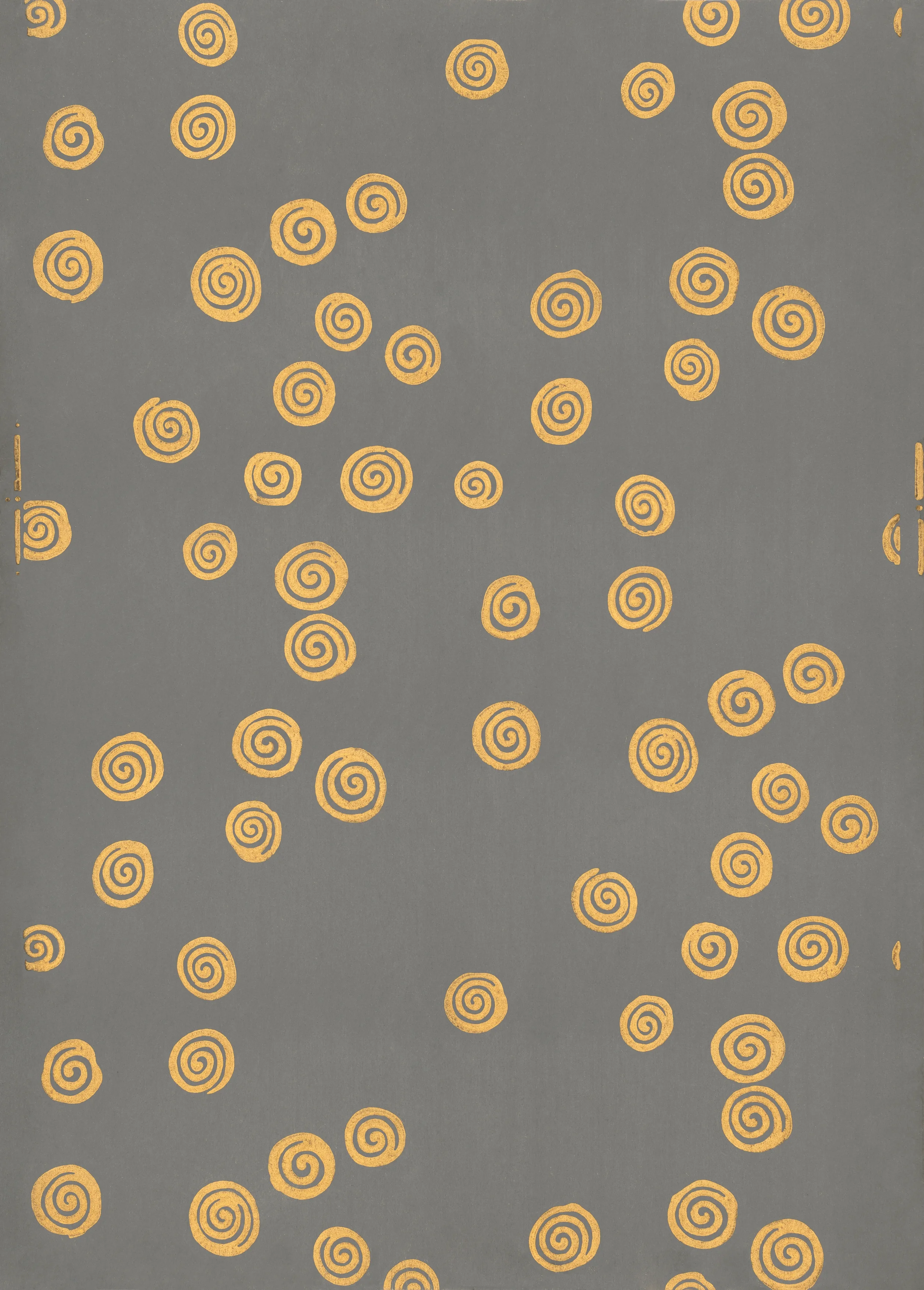 Decorative paper with a gray background and scattered yellow-orange spiral patterns.
